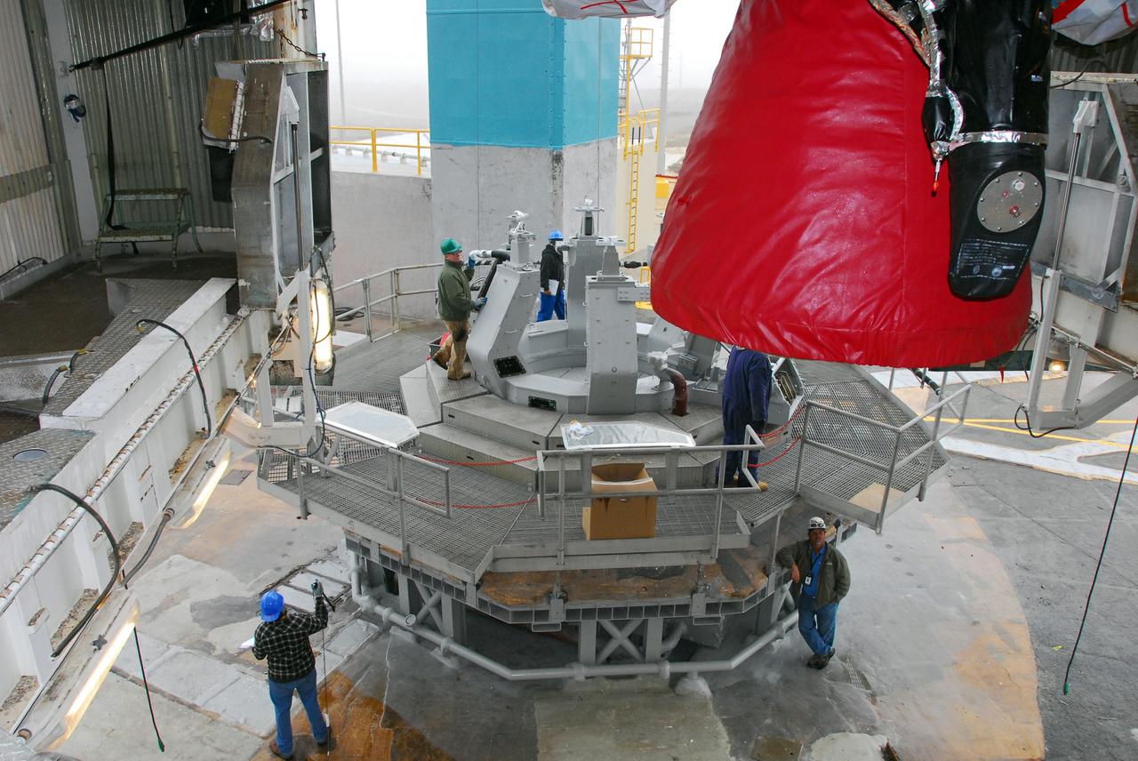 VANDENBERG AIR FORCE BASE, Calif. -- The first stage of a United Launch Alliance Delta II is hoisted into place at NASA's Space Launch Complex-2 on Vandenberg Air Force Base in California. Seen here in red is the Rocketdyne engine that will help loft the rocket off the pad. The rocket will carry NASA's National Polar-orbiting Operational Environmental Satellite System Preparatory Project (NPP) satellite into space.    NPP will be positioned 512 miles above the Earth's surface and will orbit about 16 times each day to observe nearly the entire globe. The NPP mission for NASA and the National Oceanic and Atmospheric Administration (NOAA) is to measure Earth's atmospheric and sea surface temperatures, humidity sounding, land and ocean biological activity, and cloud and aerosol properties. For more information, visit www.nasa.gov/NPP. Photo credit: NASA/VAFB, Mark Mackley