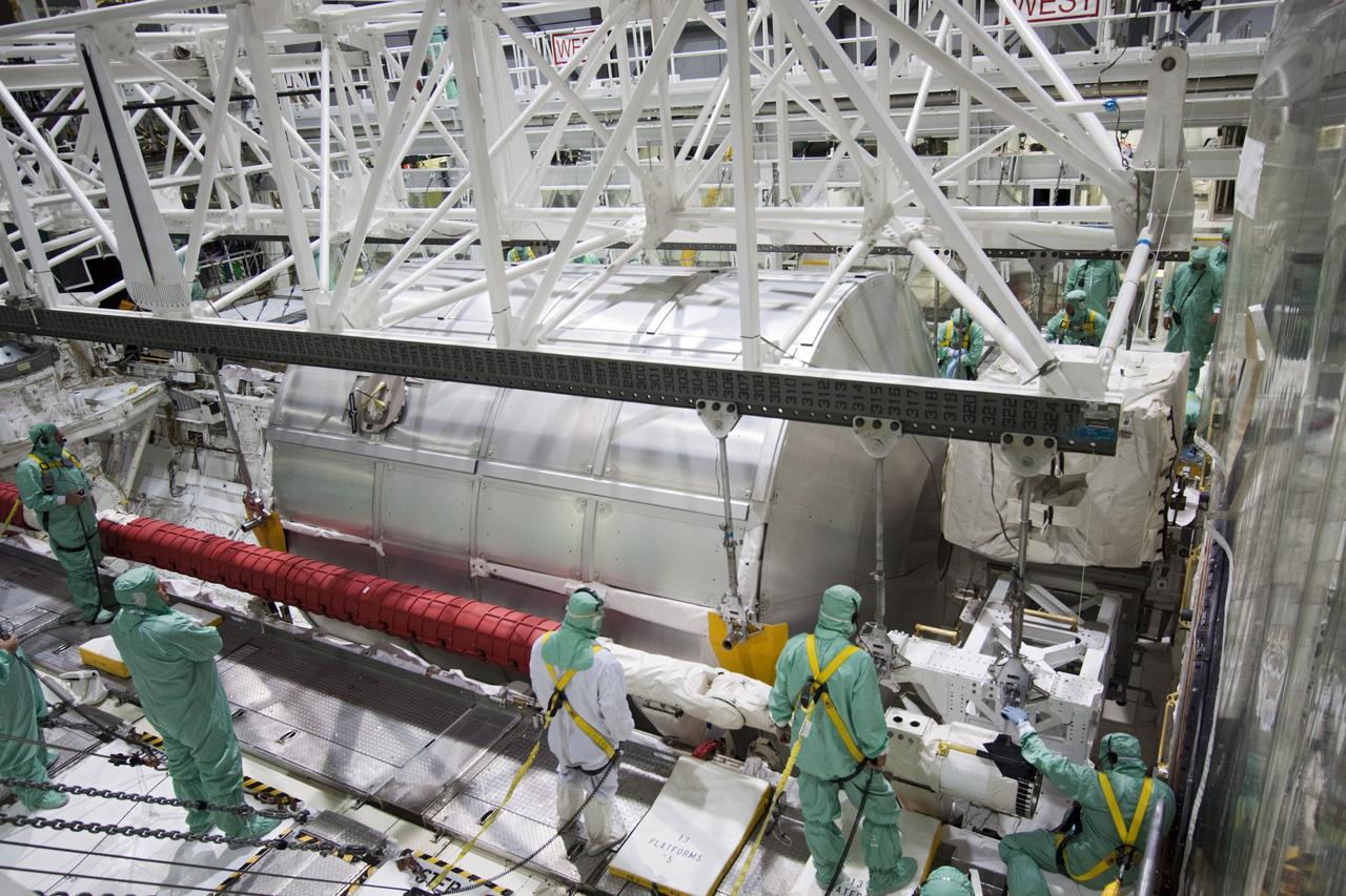 CAPE CANAVERAL, Fla. -- In Orbiter Processing Facility-2 (OPF-2) at NASA’s Kennedy Space Center in Florida, technicians monitor the progress as a special payload removal device begins to lift the Raffaello multi-purpose logistics module from Atlantis’ cargo bay. Raffaello will then be readied for transport to the Space Station Processing Facility where its contents will be unloaded. Atlantis completed NASA’s final space shuttle mission, STS-135, after landing at the center’s Shuttle Landing Facility, July 21, 2011, at 5:57 a.m. EDT. Following removal of all payloads in Atlantis’ cargo bay, workers will begin to prepare the spacecraft for eventual permanent display at the Kennedy Space Center Visitor Complex. Photo credit: Jim Grossman