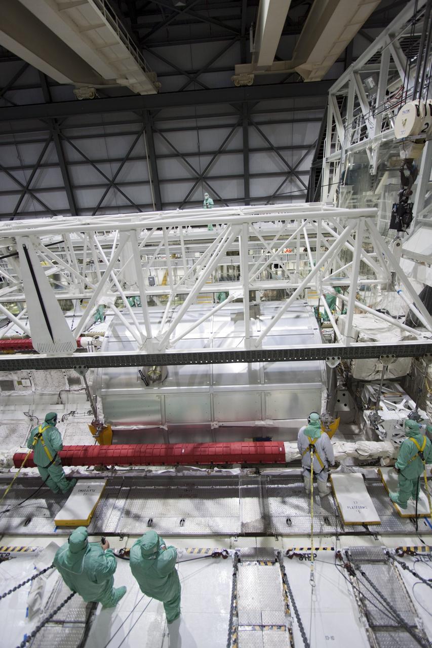 CAPE CANAVERAL, Fla. -- In Orbiter Processing Facility-2 (OPF-2) at NASA’s Kennedy Space Center in Florida, technicians monitor the progress as a special payload removal device begins to lift the Raffaello multi-purpose logistics module from Atlantis’ cargo bay. Raffaello will then be readied for transport to the Space Station Processing Facility where its contents will be unloaded. Atlantis completed NASA’s final space shuttle mission, STS-135, after landing at the center’s Shuttle Landing Facility, July 21, 2011, at 5:57 a.m. EDT. Following removal of all payloads in Atlantis’ cargo bay, workers will begin to prepare the spacecraft for eventual permanent display at the Kennedy Space Center Visitor Complex. Photo credit: Jim Grossman