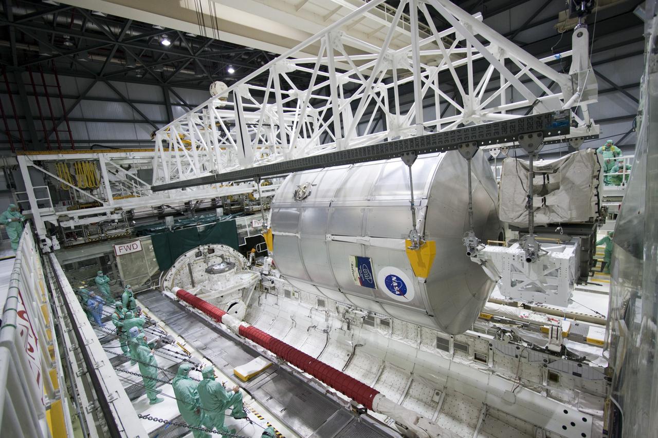 CAPE CANAVERAL, Fla. -- In Orbiter Processing Facility-2 (OPF-2) at NASA’s Kennedy Space Center in Florida, technicians monitor the progress as a special payload removal device lifts the Raffaello multi-purpose logistics module from Atlantis’ cargo bay. Raffaello will then be readied for transport to the Space Station Processing Facility where its contents will be unloaded. Atlantis completed NASA’s final space shuttle mission, STS-135, after landing at the center’s Shuttle Landing Facility, July 21, 2011, at 5:57 a.m. EDT. Following removal of all payloads in Atlantis’ cargo bay, workers will begin to prepare the spacecraft for eventual permanent display at the Kennedy Space Center Visitor Complex. Photo credit: Jim Grossman
