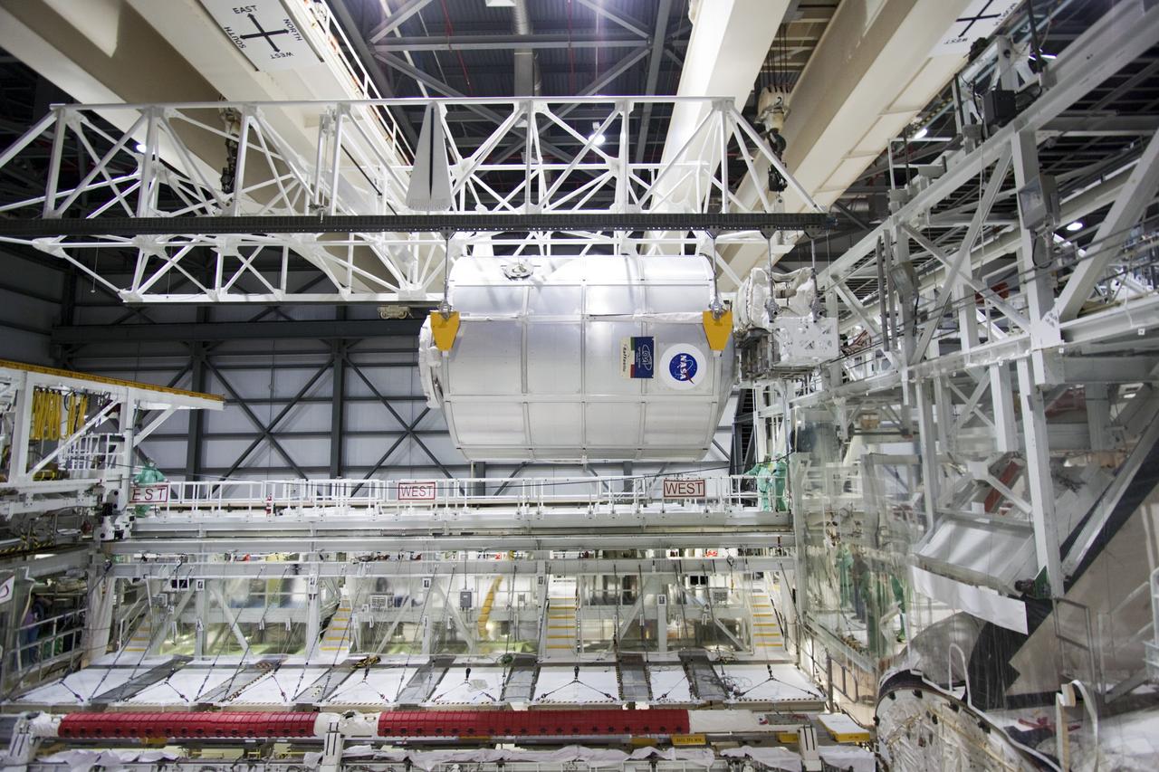 CAPE CANAVERAL, Fla. -- In Orbiter Processing Facility-2 (OPF-2) at NASA’s Kennedy Space Center in Florida, a special payload removal device is used to lift the Raffaello multi-purpose logistics module high above Atlantis’ cargo bay. Raffaello will then be readied for transport to the Space Station Processing Facility where its contents will be unloaded. Atlantis completed NASA’s final space shuttle mission, STS-135, after landing at the center’s Shuttle Landing Facility, July 21, 2011, at 5:57 a.m. EDT. Following removal of all payloads in Atlantis’ cargo bay, workers will begin to prepare the spacecraft for eventual permanent display at the Kennedy Space Center Visitor Complex. Photo credit: Jim Grossman