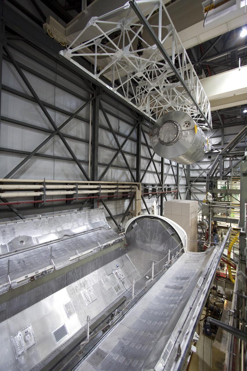 CAPE CANAVERAL, Fla. -- In Orbiter Processing Facility-2 (OPF-2) at NASA’s Kennedy Space Center in Florida, a special payload removal device is used to lift the Raffaello multi-purpose logistics module away from Atlantis’ cargo bay. Raffaello will then be readied for transport to the Space Station Processing Facility where its contents will be unloaded. Atlantis completed NASA’s final space shuttle mission, STS-135, after landing at the center’s Shuttle Landing Facility, July 21, 2011, at 5:57 a.m. EDT. Following removal of all payloads in Atlantis’ cargo bay, workers will begin to prepare the spacecraft for eventual permanent display at the Kennedy Space Center Visitor Complex. Photo credit: Jim Grossman