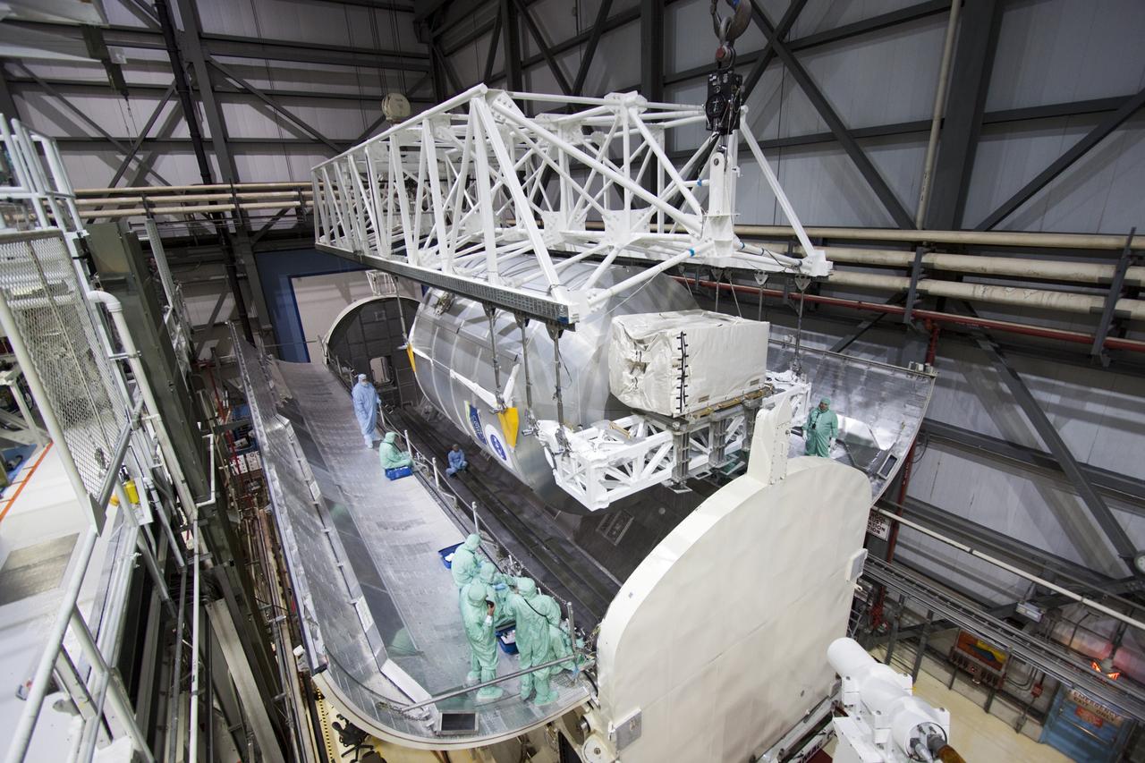 CAPE CANAVERAL, Fla. -- In Orbiter Processing Facility-2 (OPF-2) at NASA’s Kennedy Space Center in Florida, technicians monitor the progress as a special payload removal device is used to transfer the Raffaello multi-purpose logistics module from Atlantis’ cargo bay to the payload canister. Raffaello will then be readied for transport to the Space Station Processing Facility where its contents will be unloaded. Atlantis completed NASA’s final space shuttle mission, STS-135, after landing at the center’s Shuttle Landing Facility, July 21, 2011, at 5:57 a.m. EDT. Following removal of all payloads in Atlantis’ cargo bay, workers will begin to prepare the spacecraft for eventual permanent display at the Kennedy Space Center Visitor Complex. Photo credit: Jim Grossman