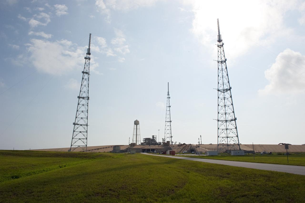 CAPE CANAVERAL, Fla. -- At NASA's Kennedy Space Center in Florida, the water tower and lightning protection system, consisting of three 600-foot-tall lightning towers, remain at Launch Pad 39B after the pad's deconstruction.  Each lightning tower is 500 feet tall and topped off with an additional 100-foot fiberglass mast which supports a wire catenary system.      In 2009, the structure at the pad was no longer needed for NASA's Space Shuttle Program, so it is being restructured for future use. The new design will feature a "clean pad" for rockets to come with their own launcher, making it more versatile for a number of vehicles. For information on NASA's future plans, visit http://www.nasa.gov/exploration. Photo credit: NASA/Kim Shiflett