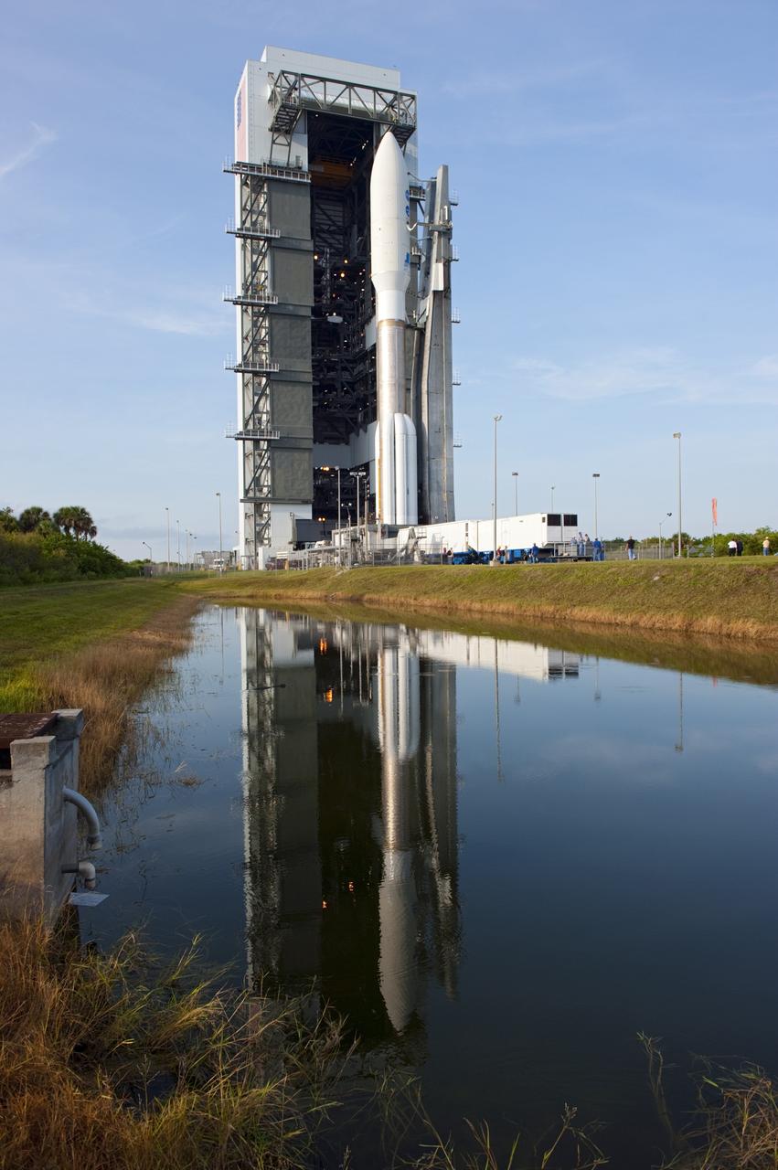 CAPE CANAVERAL, Fla. -- On Cape Canaveral Air Force Station in Florida, the 197-foot-tall United Launch Alliance Atlas V-551 launch vehicle is reflected in the water near the Vertical Integration Facility as it rolls to Space Launch Complex 41.  Atop the rocket is NASA's Juno spacecraft, enclosed in its payload fairing.    Liftoff is planned during a launch window which extends from 11:34 a.m. to 12:43 p.m. EDT on Aug. 5. The solar-powered spacecraft will orbit Jupiter's poles 33 times to find out more about the gas giant's origins, structure, atmosphere and magnetosphere and investigate the existence of a solid planetary core. NASA's Jet Propulsion Laboratory, Pasadena, Calif., manages the Juno mission for the principal investigator, Scott Bolton, of Southwest Research Institute in San Antonio. The Juno mission is part of the New Frontiers Program managed at NASA's Marshall Space Flight Center in Huntsville, Ala. Lockheed Martin Space Systems, Denver, built the spacecraft. Launch management for the mission is the responsibility of NASA's Launch Services Program at the Kennedy Space Center in Florida.  For more information, visit www.nasa.gov/juno. Photo credit: NASA/Kim Shiflett