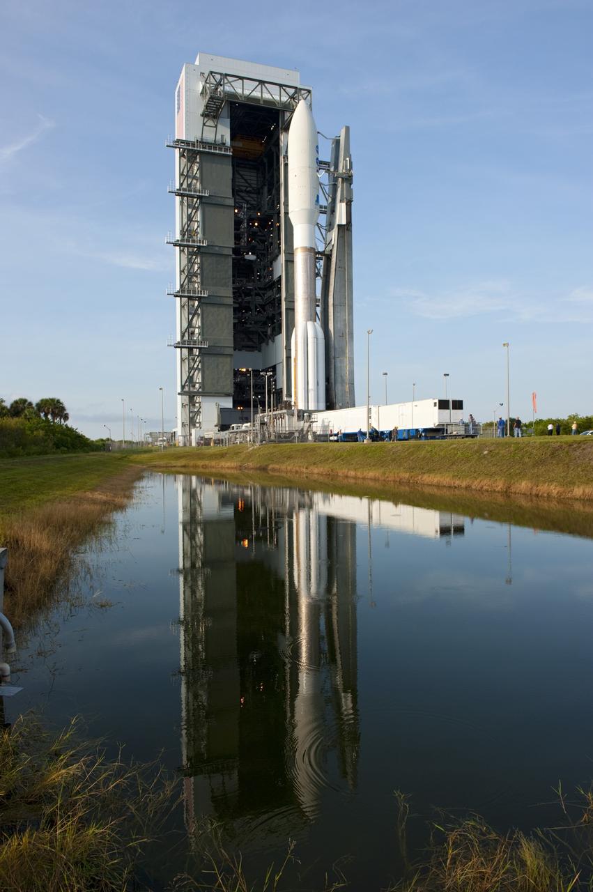 CAPE CANAVERAL, Fla. -- On Cape Canaveral Air Force Station in Florida, the 197-foot-tall United Launch Alliance Atlas V-551 launch vehicle is reflected in the water near the Vertical Integration Facility as it rolls to Space Launch Complex 41.  Atop the rocket is NASA's Juno spacecraft, enclosed in its payload fairing.    Liftoff is planned during a launch window which extends from 11:34 a.m. to 12:43 p.m. EDT on Aug. 5. The solar-powered spacecraft will orbit Jupiter's poles 33 times to find out more about the gas giant's origins, structure, atmosphere and magnetosphere and investigate the existence of a solid planetary core. NASA's Jet Propulsion Laboratory, Pasadena, Calif., manages the Juno mission for the principal investigator, Scott Bolton, of Southwest Research Institute in San Antonio. The Juno mission is part of the New Frontiers Program managed at NASA's Marshall Space Flight Center in Huntsville, Ala. Lockheed Martin Space Systems, Denver, built the spacecraft. Launch management for the mission is the responsibility of NASA's Launch Services Program at the Kennedy Space Center in Florida.  For more information, visit www.nasa.gov/juno. Photo credit: NASA/Kim Shiflett