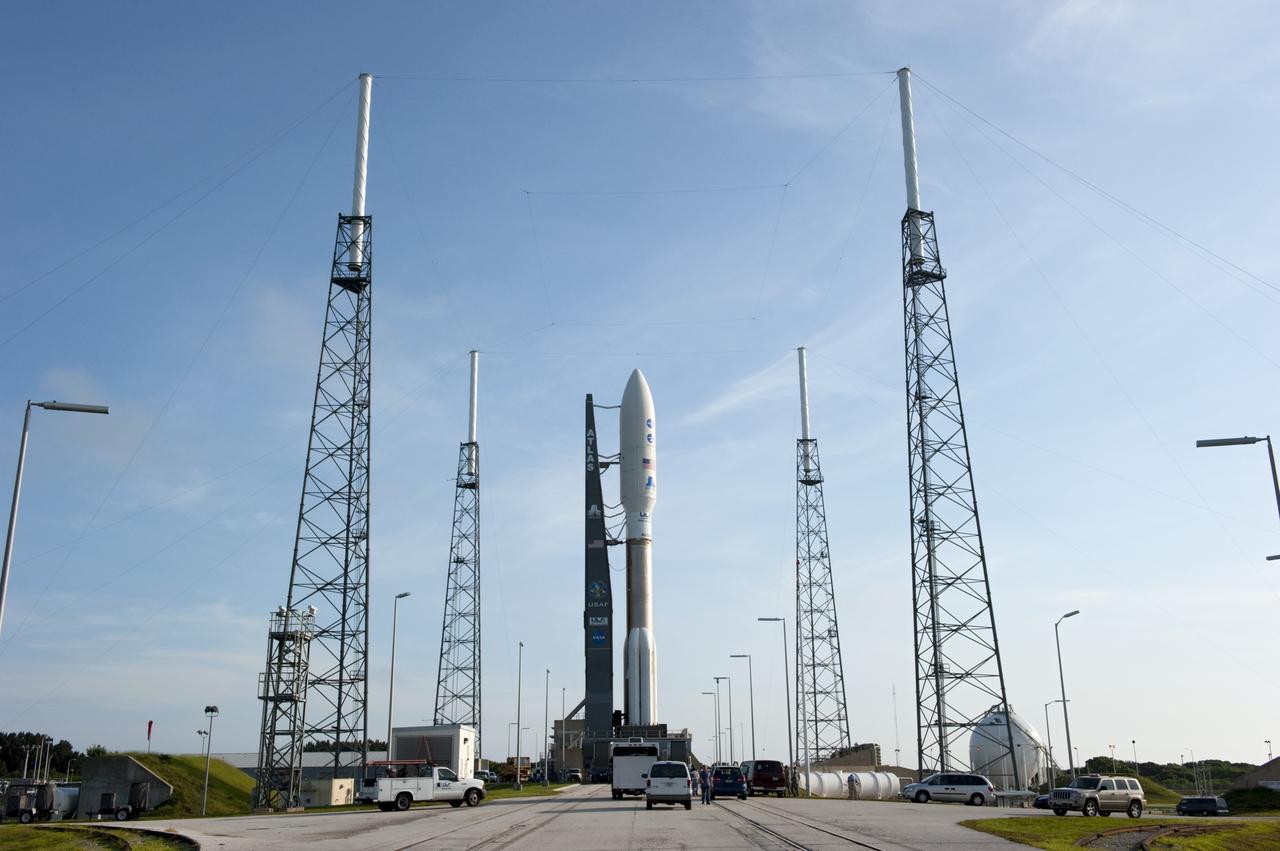 CAPE CANAVERAL, Fla. -- NASA's Juno spacecraft, enclosed in its payload fairing atop a United Launch Alliance Atlas V-551 launch vehicle, rolls between the towers of the lightning protection system toward the launch pad at Space Launch Complex 41 on Cape Canaveral Air Force Station in Florida.    Liftoff is planned during a launch window which extends from 11:34 a.m. to 12:43 p.m. EDT on Aug. 5. The solar-powered spacecraft will orbit Jupiter's poles 33 times to find out more about the gas giant's origins, structure, atmosphere and magnetosphere and investigate the existence of a solid planetary core. NASA's Jet Propulsion Laboratory, Pasadena, Calif., manages the Juno mission for the principal investigator, Scott Bolton, of Southwest Research Institute in San Antonio. The Juno mission is part of the New Frontiers Program managed at NASA's Marshall Space Flight Center in Huntsville, Ala. Lockheed Martin Space Systems, Denver, built the spacecraft. Launch management for the mission is the responsibility of NASA's Launch Services Program at the Kennedy Space Center in Florida.  For more information, visit www.nasa.gov/juno. Photo credit: NASA/Kim Shiflett