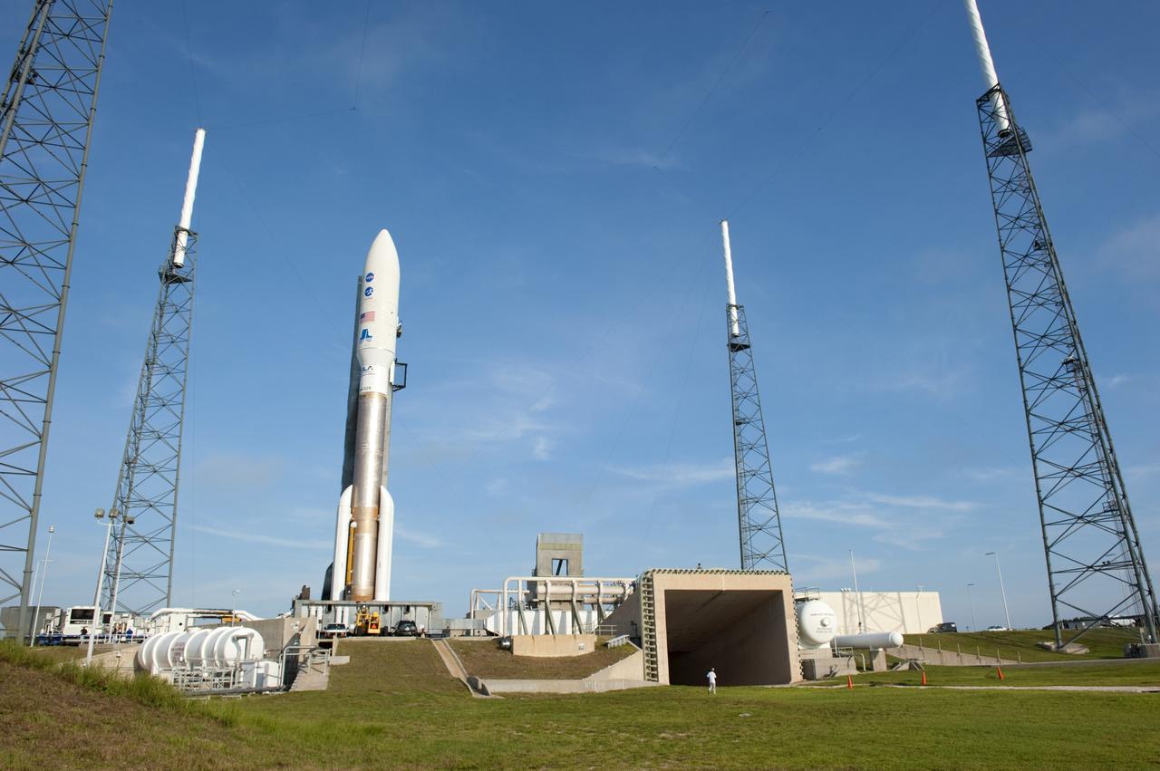 CAPE CANAVERAL, Fla. -- NASA's Juno spacecraft, enclosed in its payload fairing atop a United Launch Alliance Atlas V-551 launch vehicle, is nestled between the towers of the lightning protection system beside the exhaust duct on the launch pad at Space Launch Complex 41 on Cape Canaveral Air Force Station in Florida.    Liftoff is planned during a launch window which extends from 11:34 a.m. to 12:43 p.m. EDT on Aug. 5. The solar-powered spacecraft will orbit Jupiter's poles 33 times to find out more about the gas giant's origins, structure, atmosphere and magnetosphere and investigate the existence of a solid planetary core. NASA's Jet Propulsion Laboratory, Pasadena, Calif., manages the Juno mission for the principal investigator, Scott Bolton, of Southwest Research Institute in San Antonio. The Juno mission is part of the New Frontiers Program managed at NASA's Marshall Space Flight Center in Huntsville, Ala. Lockheed Martin Space Systems, Denver, built the spacecraft. Launch management for the mission is the responsibility of NASA's Launch Services Program at the Kennedy Space Center in Florida.  For more information, visit www.nasa.gov/juno. Photo credit: NASA/Kim Shiflett