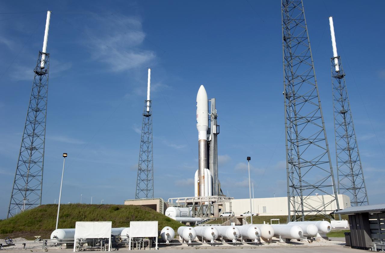 CAPE CANAVERAL, Fla. -- NASA's Juno spacecraft, enclosed in its payload fairing atop a United Launch Alliance Atlas V-551 launch vehicle, is nestled between the towers of the lightning protection system at Space Launch Complex 41 on Cape Canaveral Air Force Station in Florida.    Launch is planned during a launch window which extends from 11:34 a.m. to 12:43 p.m. EDT on Aug. 5. The solar-powered spacecraft will orbit Jupiter's poles 33 times to find out more about the gas giant's origins, structure, atmosphere and magnetosphere and investigate the existence of a solid planetary core. NASA's Jet Propulsion Laboratory, Pasadena, Calif., manages the Juno mission for the principal investigator, Scott Bolton, of Southwest Research Institute in San Antonio. The Juno mission is part of the New Frontiers Program managed at NASA's Marshall Space Flight Center in Huntsville, Ala. Lockheed Martin Space Systems, Denver, built the spacecraft. Launch management for the mission is the responsibility of NASA's Launch Services Program at the Kennedy Space Center in Florida.  For more information, visit www.nasa.gov/juno. Photo credit: NASA/Kim Shiflett