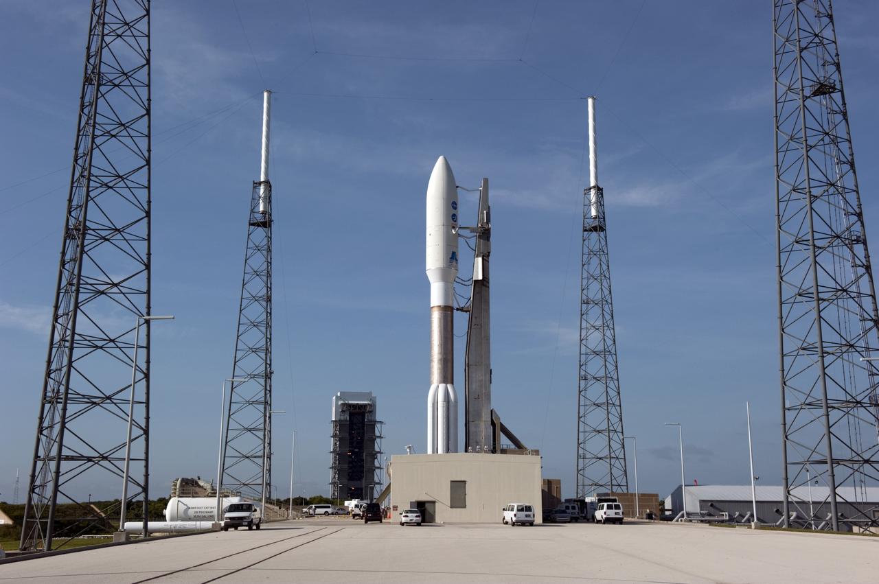 CAPE CANAVERAL, Fla. -- NASA's Juno spacecraft, enclosed in its payload fairing atop a United Launch Alliance Atlas V-551 launch vehicle, is nestled between the towers of the lightning protection system at Space Launch Complex 41 on Cape Canaveral Air Force Station in Florida.  In the background is the Vertical Integration Facility where the rocket was stacked.    Launch is planned during a launch window which extends from 11:34 a.m. to 12:43 p.m. EDT on Aug. 5. The solar-powered spacecraft will orbit Jupiter's poles 33 times to find out more about the gas giant's origins, structure, atmosphere and magnetosphere and investigate the existence of a solid planetary core. NASA's Jet Propulsion Laboratory, Pasadena, Calif., manages the Juno mission for the principal investigator, Scott Bolton, of Southwest Research Institute in San Antonio. The Juno mission is part of the New Frontiers Program managed at NASA's Marshall Space Flight Center in Huntsville, Ala. Lockheed Martin Space Systems, Denver, built the spacecraft. Launch management for the mission is the responsibility of NASA's Launch Services Program at the Kennedy Space Center in Florida.  For more information, visit www.nasa.gov/juno. Photo credit: NASA/Kim Shiflett