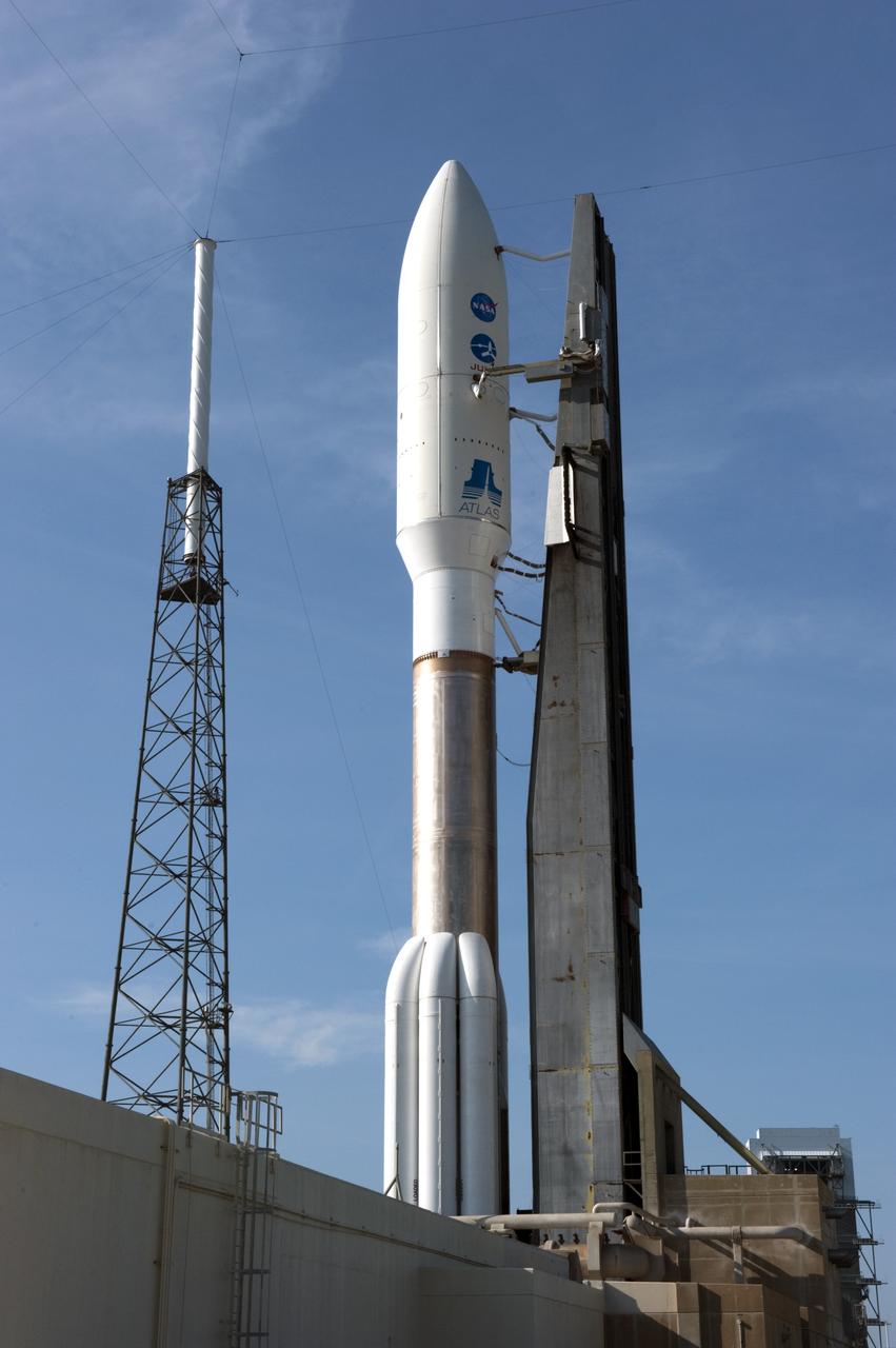 CAPE CANAVERAL, Fla. -- NASA's Juno spacecraft, enclosed in its payload fairing atop a United Launch Alliance Atlas V-551 launch vehicle, is protected from potential stormy weather by the wire catenary system traversing the towers of the lightning protection system at Space Launch Complex 41 on Cape Canaveral Air Force Station in Florida.     Launch is planned during a launch window which extends from 11:34 a.m. to 12:43 p.m. EDT on Aug. 5. The solar-powered spacecraft will orbit Jupiter's poles 33 times to find out more about the gas giant's origins, structure, atmosphere and magnetosphere and investigate the existence of a solid planetary core. NASA's Jet Propulsion Laboratory, Pasadena, Calif., manages the Juno mission for the principal investigator, Scott Bolton, of Southwest Research Institute in San Antonio. The Juno mission is part of the New Frontiers Program managed at NASA's Marshall Space Flight Center in Huntsville, Ala. Lockheed Martin Space Systems, Denver, built the spacecraft. Launch management for the mission is the responsibility of NASA's Launch Services Program at the Kennedy Space Center in Florida.  For more information, visit www.nasa.gov/juno. Photo credit: NASA/Kim Shiflett