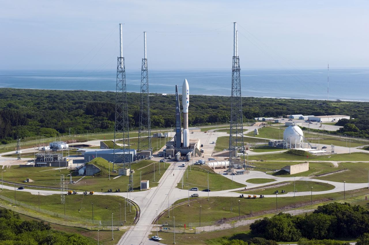 CAPE CANAVERAL, Fla. -- NASA's Juno spacecraft, enclosed in its payload fairing atop a United Launch Alliance Atlas V-551 launch vehicle, is nestled between the towers of the lightning protection system at Space Launch Complex 41 on Cape Canaveral Air Force Station in Florida.    The water of the Atlantic Ocean rolls in the distance as far as the eye can see.    Launch is planned during a launch window which extends from 11:34 a.m. to 12:43 p.m. EDT on Aug. 5. The solar-powered spacecraft will orbit Jupiter's poles 33 times to find out more about the gas giant's origins, structure, atmosphere and magnetosphere and investigate the existence of a solid planetary core. NASA's Jet Propulsion Laboratory, Pasadena, Calif., manages the Juno mission for the principal investigator, Scott Bolton, of Southwest Research Institute in San Antonio. The Juno mission is part of the New Frontiers Program managed at NASA's Marshall Space Flight Center in Huntsville, Ala. Lockheed Martin Space Systems, Denver, built the spacecraft. Launch management for the mission is the responsibility of NASA's Launch Services Program at the Kennedy Space Center in Florida.  For more information, visit www.nasa.gov/juno. Photo credit: NASA/Kim Shiflett