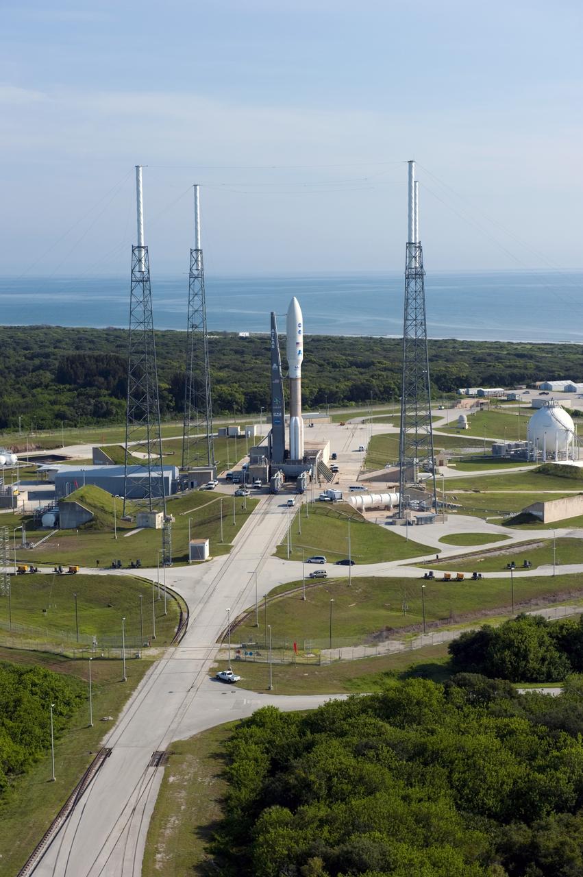 CAPE CANAVERAL, Fla. -- NASA's Juno spacecraft, enclosed in its payload fairing atop a United Launch Alliance Atlas V-551 launch vehicle, is protected from potential stormy weather by the wire catenary system traversing the towers of the lightning protection system at Space Launch Complex 41 on Cape Canaveral Air Force Station in Florida.  The Atlantic Ocean behind the pad extends into the distance.    Launch is planned during a launch window which extends from 11:34 a.m. to 12:43 p.m. EDT on Aug. 5. The solar-powered spacecraft will orbit Jupiter's poles 33 times to find out more about the gas giant's origins, structure, atmosphere and magnetosphere and investigate the existence of a solid planetary core. NASA's Jet Propulsion Laboratory, Pasadena, Calif., manages the Juno mission for the principal investigator, Scott Bolton, of Southwest Research Institute in San Antonio. The Juno mission is part of the New Frontiers Program managed at NASA's Marshall Space Flight Center in Huntsville, Ala. Lockheed Martin Space Systems, Denver, built the spacecraft. Launch management for the mission is the responsibility of NASA's Launch Services Program at the Kennedy Space Center in Florida.  For more information, visit www.nasa.gov/juno. Photo credit: NASA/Kim Shiflett