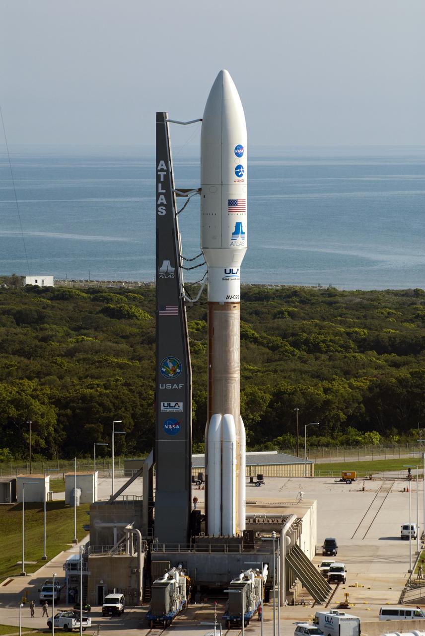 CAPE CANAVERAL, Fla. -- NASA's Juno spacecraft, enclosed in its payload fairing atop a United Launch Alliance Atlas V-551 launch vehicle, stands on its seaside launch pad at Space Launch Complex 41 on Cape Canaveral Air Force Station in Florida.  The water of the Atlantic Ocean swirls in the distance.    Launch is planned during a launch window which extends from 11:34 a.m. to 12:43 p.m. EDT on Aug. 5. The solar-powered spacecraft will orbit Jupiter's poles 33 times to find out more about the gas giant's origins, structure, atmosphere and magnetosphere and investigate the existence of a solid planetary core. NASA's Jet Propulsion Laboratory, Pasadena, Calif., manages the Juno mission for the principal investigator, Scott Bolton, of Southwest Research Institute in San Antonio. The Juno mission is part of the New Frontiers Program managed at NASA's Marshall Space Flight Center in Huntsville, Ala. Lockheed Martin Space Systems, Denver, built the spacecraft. Launch management for the mission is the responsibility of NASA's Launch Services Program at the Kennedy Space Center in Florida.  For more information, visit www.nasa.gov/juno. Photo credit: NASA/Kim Shiflett