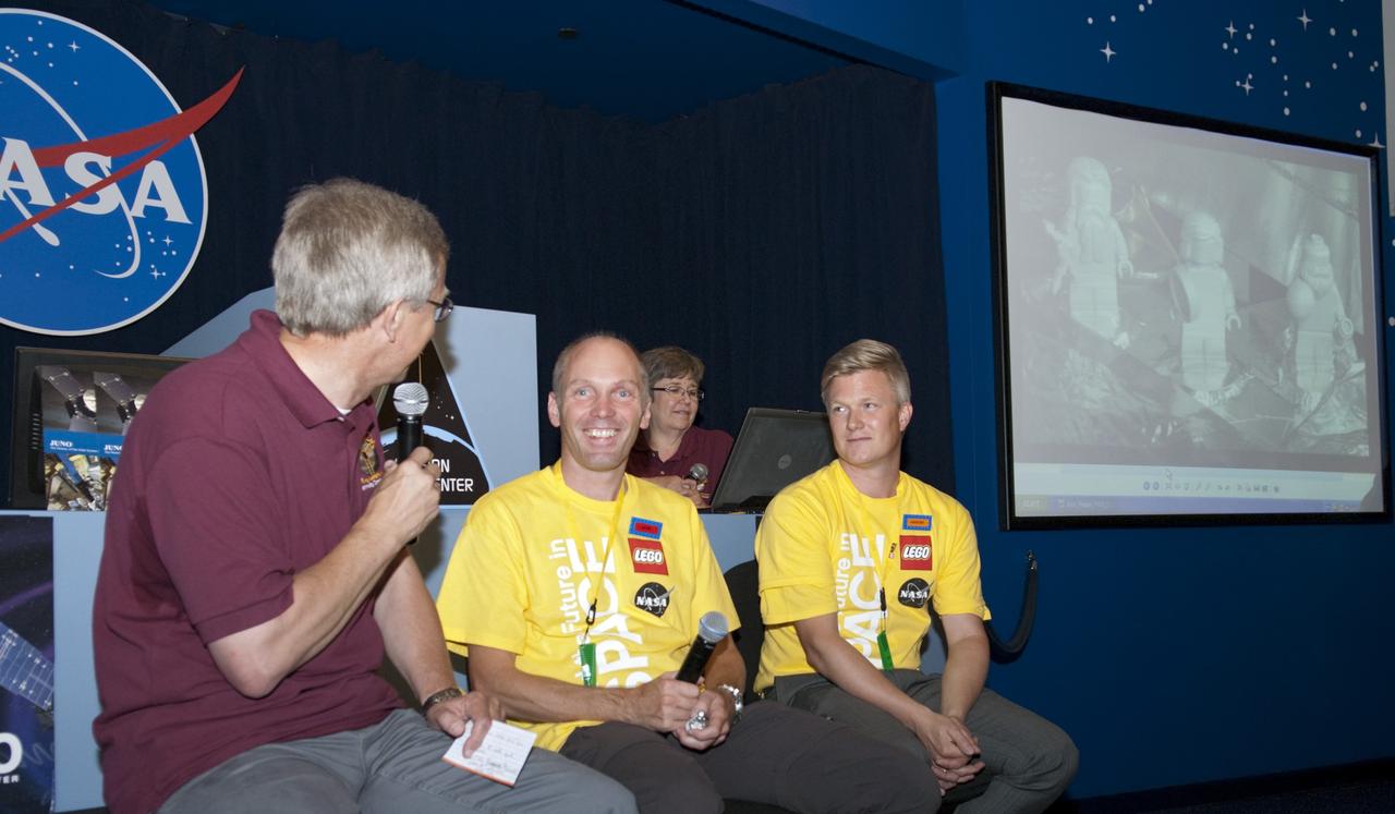 CAPE CANAVERAL, Fla. -- From left, Dr. Steve Lee, with the Denver Museum of Nature and Science; Ulrik Solberg Lund, a LEGO minifigure designer; and Karsten Juel Bunch, a LEGO City senior designer, participate in an educational webcast in the Mission Status Center at the Kennedy Space Center Visitor Complex in Florida. On hand to ask questions of the guests were students, teachers, and mentors of the Goldstone Apple Valley Radio Telescope (GAVRT) project who were invited to Kennedy to watch the launch of NASA's Juno spacecraft atop a United Launch Alliance Atlas V rocket.      GAVRT is a partnership between NASA, the Jet Propulsion Laboratory (JPL), and The Lewis Center for Educational Research (LCER) in Apple Valley, Calif. It allows students to control a 34-meter radio telescope that, until recently, was part of NASA’s Deep Space Network, and to interact with scientists outside the classroom setting. Photo credit: NASA/Glenn Benson
