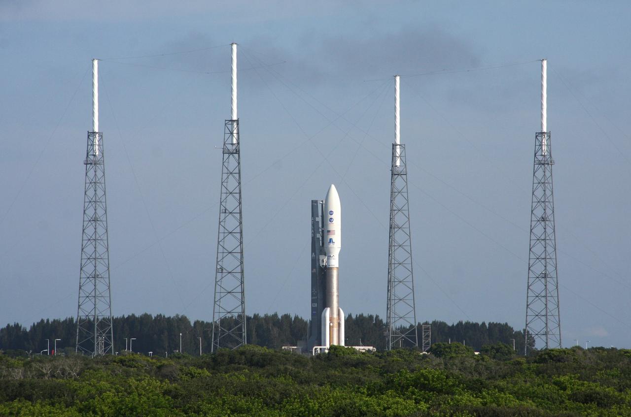 CAPE CANAVERAL, Fla. -- NASA's Juno spacecraft, enclosed in its payload fairing atop a United Launch Alliance Atlas V-551 launch vehicle, is protected from potential stormy weather by the wire catenary system traversing the towers of the lightning protection system at Space Launch Complex 41 on Cape Canaveral Air Force Station in Florida.    Liftoff is planned during a launch window which extends from 11:34 a.m. to 12:43 p.m. EDT on Aug. 5. The solar-powered spacecraft will orbit Jupiter's poles 33 times to find out more about the gas giant's origins, structure, atmosphere and magnetosphere and investigate the existence of a solid planetary core. NASA's Jet Propulsion Laboratory, Pasadena, Calif., manages the Juno mission for the principal investigator, Scott Bolton, of Southwest Research Institute in San Antonio. The Juno mission is part of the New Frontiers Program managed at NASA's Marshall Space Flight Center in Huntsville, Ala. Lockheed Martin Space Systems, Denver, built the spacecraft. Launch management for the mission is the responsibility of NASA's Launch Services Program at the Kennedy Space Center in Florida.  For more information, visit www.nasa.gov/juno. Photo credit: NASA/Ken Thornsley