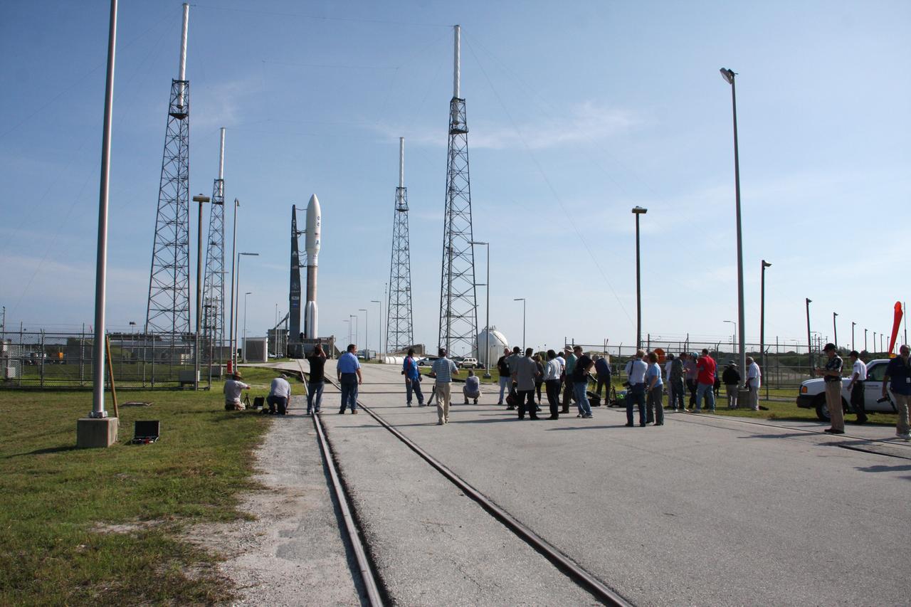 CAPE CANAVERAL, Fla. -- On Cape Canaveral Air Force Station in Florida, representatives of media outlets worldwide witness the arrival of the 197-foot-tall United Launch Alliance Atlas V-551 launch vehicle, carrying NASA's Juno spacecraft, on the launch pad at Space Launch Complex 41.    Liftoff is planned during a launch window which extends from 11:34 a.m. to 12:43 p.m. EDT on Aug. 5. The solar-powered spacecraft will orbit Jupiter's poles 33 times to find out more about the gas giant's origins, structure, atmosphere and magnetosphere and investigate the existence of a solid planetary core. NASA's Jet Propulsion Laboratory, Pasadena, Calif., manages the Juno mission for the principal investigator, Scott Bolton, of Southwest Research Institute in San Antonio. The Juno mission is part of the New Frontiers Program managed at NASA's Marshall Space Flight Center in Huntsville, Ala. Lockheed Martin Space Systems, Denver, built the spacecraft. Launch management for the mission is the responsibility of NASA's Launch Services Program at the Kennedy Space Center in Florida.  For more information, visit www.nasa.gov/juno. Photo credit: NASA/Ken Thornsley