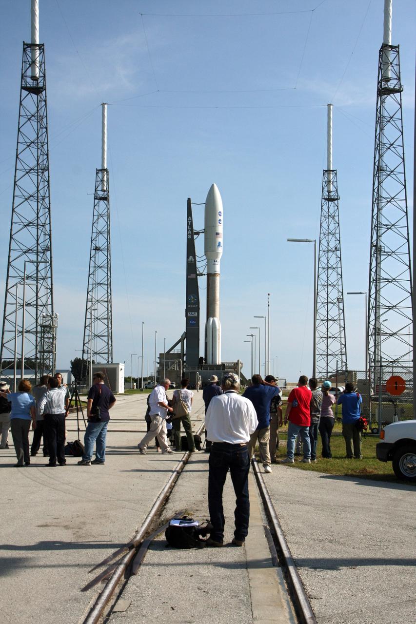 CAPE CANAVERAL, Fla. -- On Cape Canaveral Air Force Station in Florida, representatives of media outlets worldwide photograph the 197-foot-tall United Launch Alliance Atlas V-551 launch vehicle carrying NASA's Juno spacecraft upon its arrival on the launch pad at Space Launch Complex 41.    Liftoff is planned during a launch window which extends from 11:34 a.m. to 12:43 p.m. EDT on Aug. 5. The solar-powered spacecraft will orbit Jupiter's poles 33 times to find out more about the gas giant's origins, structure, atmosphere and magnetosphere and investigate the existence of a solid planetary core. NASA's Jet Propulsion Laboratory, Pasadena, Calif., manages the Juno mission for the principal investigator, Scott Bolton, of Southwest Research Institute in San Antonio. The Juno mission is part of the New Frontiers Program managed at NASA's Marshall Space Flight Center in Huntsville, Ala. Lockheed Martin Space Systems, Denver, built the spacecraft. Launch management for the mission is the responsibility of NASA's Launch Services Program at the Kennedy Space Center in Florida.  For more information, visit www.nasa.gov/juno. Photo credit: NASA/Ken Thornsley