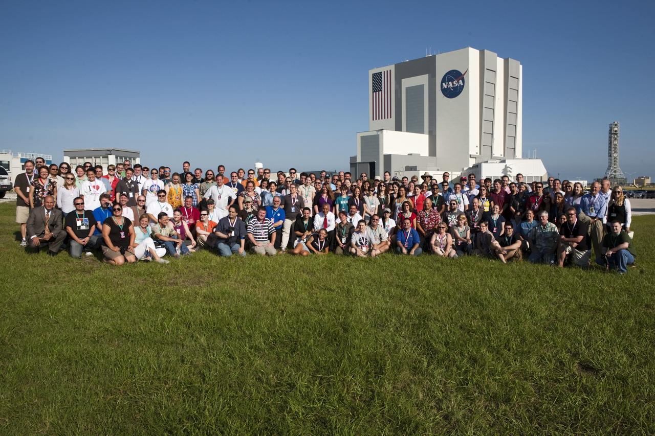 CAPE CANAVERAL, Fla. – At NASA’s Kennedy Space Center in Florida, NASA Administrator Charles Bolden (front row center, red tie) poses for a group portrait with about 150 followers of the agency’s Twitter account during Juno Tweetup activities at the Press Site. In the background is the 525-foot-tall Vehicle Assembly Building. The tweeters are at the center for two days of prelaunch activities. Juno is NASA’s mission to Jupiter to study the giant planet and improve our understanding of the planet’s formation and evolution. The tweeters will share their experiences with followers through the social networking site Twitter.    Attendees represent 28 states, the District of Columbia and five other countries: Canada, Finland, Norway, Spain and the United Kingdom. This is the first time NASA has invited Twitter followers to experience the launch of a planetary spacecraft.  The Juno spacecraft is scheduled to launch on an Atlas V rocket from Space Launch Complex 41 at Cape Canaveral Air Force Station in Florida, Aug. 5, at 11:34 a.m. EDT.  For more information, visit http://www.nasa.gov/juno.  Photo credit: NASA/Gianni M. Woods