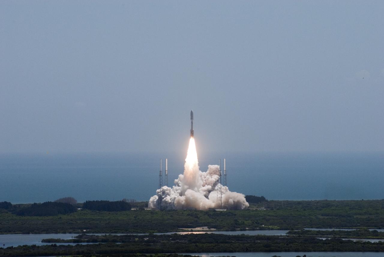 CAPE CANAVERAL, Fla. -- NASA's Juno planetary probe, enclosed in its payload fairing atop a United Launch Alliance Atlas V-551 launch vehicle, rises above the towers of the lightning protection system at Space Launch Complex 41 on Cape Canaveral Air Force Station in Florida.    Liftoff was at 12:25 p.m. EDT Aug. 5. The solar-powered spacecraft will orbit Jupiter's poles 33 times to find out more about the gas giant's origins, structure, atmosphere and magnetosphere and investigate the existence of a solid planetary core. NASA's Jet Propulsion Laboratory, Pasadena, Calif., manages the Juno mission for the principal investigator, Scott Bolton, of Southwest Research Institute in San Antonio. The Juno mission is part of the New Frontiers Program managed at NASA's Marshall Space Flight Center in Huntsville, Ala. Lockheed Martin Space Systems, Denver, built the spacecraft. Launch management for the mission is the responsibility of NASA's Launch Services Program at the Kennedy Space Center in Florida.  For more information, visit www.nasa.gov/juno. Photo credit: NASA/Jim Grossmann