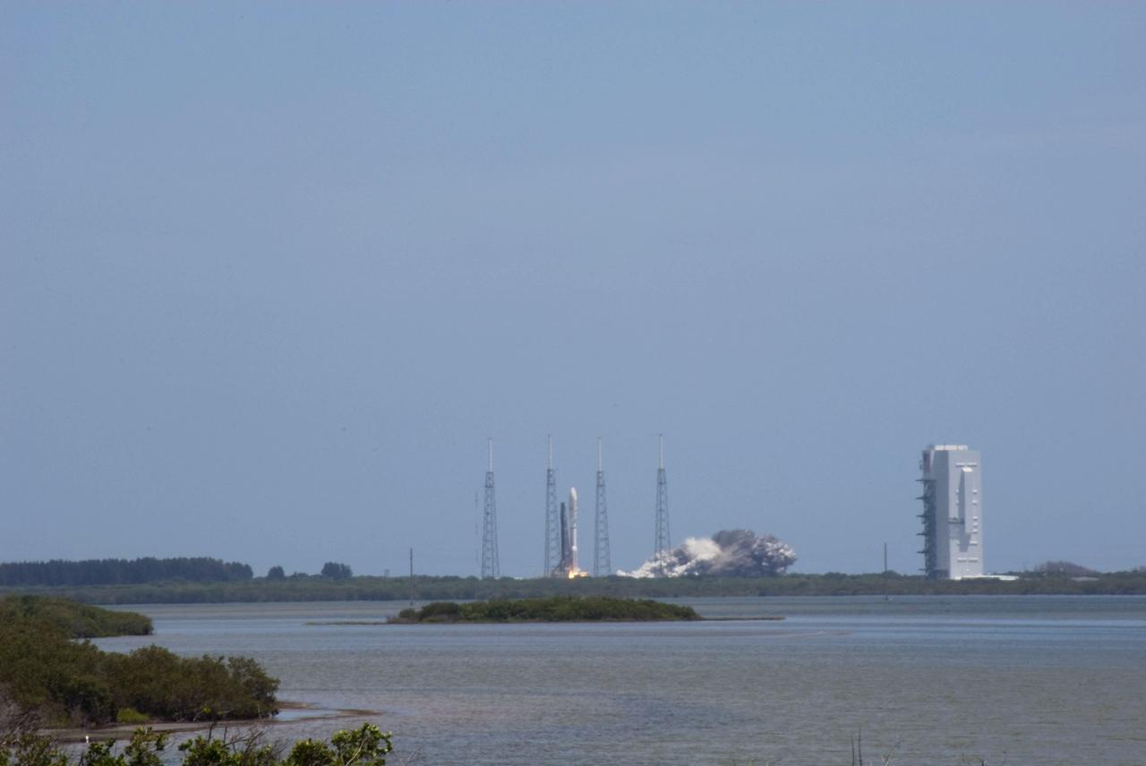 CAPE CANAVERAL, Fla. -- NASA's Juno planetary probe, enclosed in its payload fairing, begins its five-year journey to Jupiter atop a United Launch Alliance Atlas V-551 launch vehicle from Space Launch Complex 41 on Cape Canaveral Air Force Station in Florida.  At right is the Vertical Integration Facility where the vehicle was stacked.    Liftoff was at 12:25 p.m. EDT Aug. 5. The solar-powered spacecraft will orbit Jupiter's poles 33 times to find out more about the gas giant's origins, structure, atmosphere and magnetosphere and investigate the existence of a solid planetary core. NASA's Jet Propulsion Laboratory, Pasadena, Calif., manages the Juno mission for the principal investigator, Scott Bolton, of Southwest Research Institute in San Antonio. The Juno mission is part of the New Frontiers Program managed at NASA's Marshall Space Flight Center in Huntsville, Ala. Lockheed Martin Space Systems, Denver, built the spacecraft. Launch management for the mission is the responsibility of NASA's Launch Services Program at the Kennedy Space Center in Florida.  For more information, visit www.nasa.gov/juno. Photo credit: NASA/Alan Ault