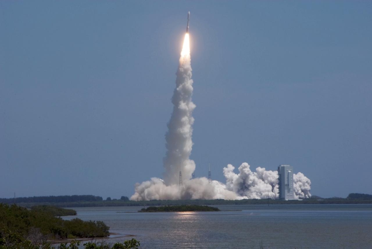 CAPE CANAVERAL, Fla. -- The United Launch Alliance Atlas V-551 launch vehicle carrying NASA's Juno planetary probe is off to a roaring start on its five-year journey to Jupiter from Space Launch Complex 41 on Cape Canaveral Air Force Station in Florida.  At right is the Vertical Integration Facility where the vehicle was stacked.    Liftoff was at 12:25 p.m. EDT Aug. 5. The solar-powered spacecraft will orbit Jupiter's poles 33 times to find out more about the gas giant's origins, structure, atmosphere and magnetosphere and investigate the existence of a solid planetary core. NASA's Jet Propulsion Laboratory, Pasadena, Calif., manages the Juno mission for the principal investigator, Scott Bolton, of Southwest Research Institute in San Antonio. The Juno mission is part of the New Frontiers Program managed at NASA's Marshall Space Flight Center in Huntsville, Ala. Lockheed Martin Space Systems, Denver, built the spacecraft. Launch management for the mission is the responsibility of NASA's Launch Services Program at the Kennedy Space Center in Florida.  For more information, visit www.nasa.gov/juno. Photo credit: NASA/Alan Ault
