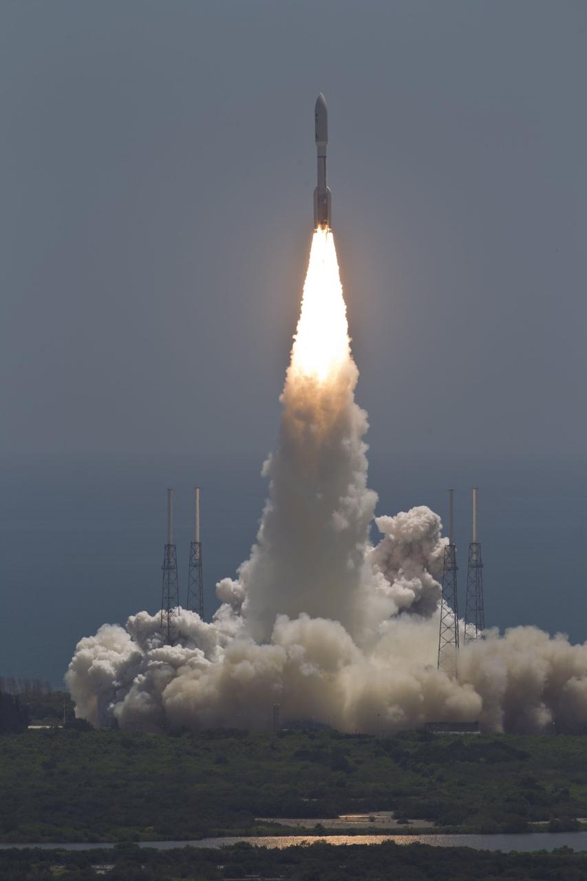 CAPE CANAVERAL, Fla. -- NASA's Juno planetary probe, enclosed in its payload fairing atop a United Launch Alliance Atlas V-551 launch vehicle, rushes above the towers of the lightning protection system at Space Launch Complex 41 on Cape Canaveral Air Force Station in Florida.    Liftoff was at 12:25 p.m. EDT Aug. 5. The solar-powered spacecraft will orbit Jupiter's poles 33 times to find out more about the gas giant's origins, structure, atmosphere and magnetosphere and investigate the existence of a solid planetary core. NASA's Jet Propulsion Laboratory, Pasadena, Calif., manages the Juno mission for the principal investigator, Scott Bolton, of Southwest Research Institute in San Antonio. The Juno mission is part of the New Frontiers Program managed at NASA's Marshall Space Flight Center in Huntsville, Ala. Lockheed Martin Space Systems, Denver, built the spacecraft. Launch management for the mission is the responsibility of NASA's Launch Services Program at the Kennedy Space Center in Florida.  For more information, visit www.nasa.gov/juno. Photo credit: Courtesy of Scott Andrews