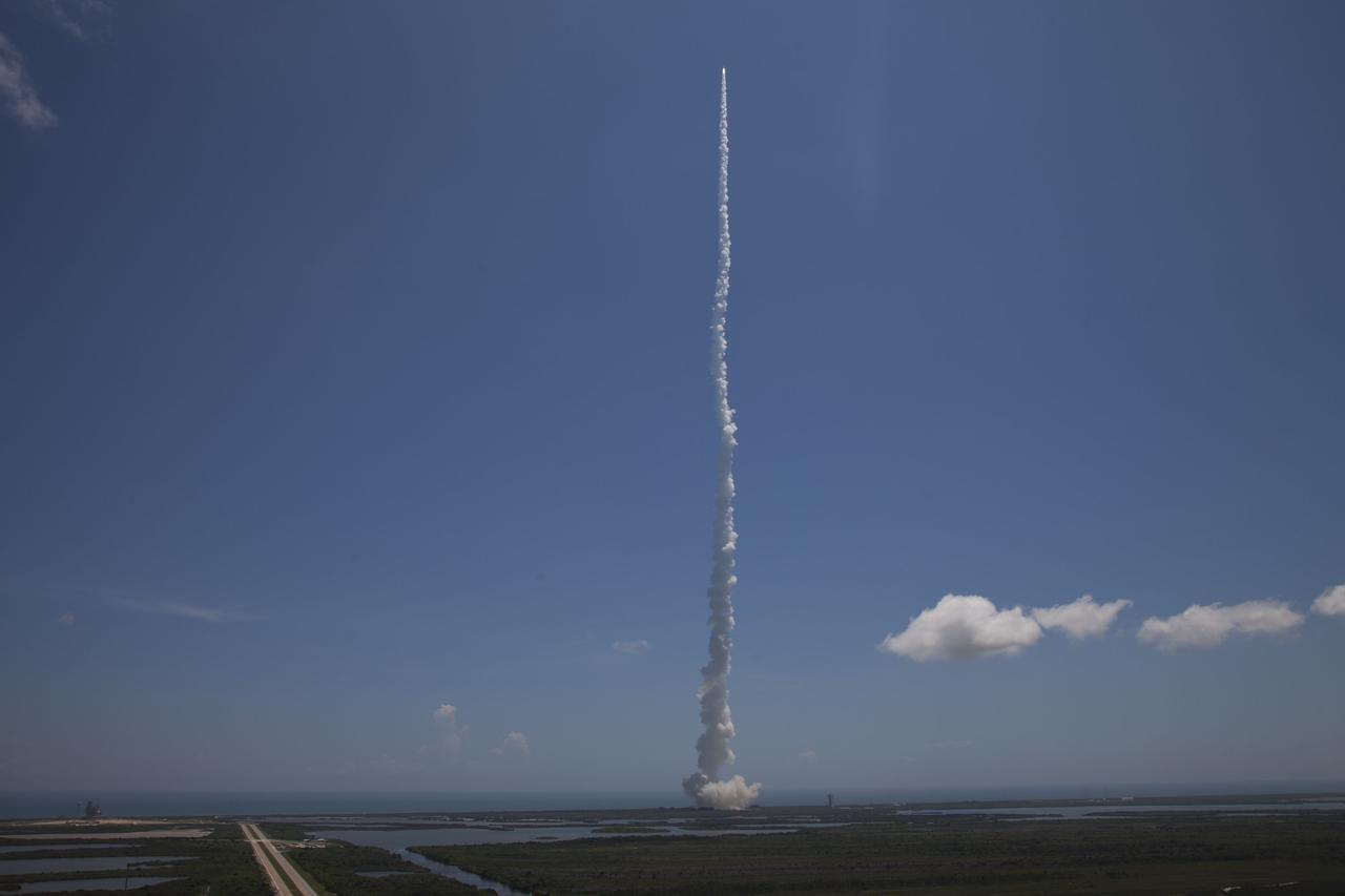 CAPE CANAVERAL, Fla. -- NASA's Juno planetary probe, atop a United Launch Alliance Atlas V-551 launch vehicle, races past the clouds over Space Launch Complex 41 at Cape Canaveral Air Force Station in Florida to begin its five-year journey to Jupiter.    Liftoff was at 12:25 p.m. EDT Aug. 5. The solar-powered spacecraft will orbit Jupiter's poles 33 times to find out more about the gas giant's origins, structure, atmosphere and magnetosphere and investigate the existence of a solid planetary core. NASA's Jet Propulsion Laboratory, Pasadena, Calif., manages the Juno mission for the principal investigator, Scott Bolton, of Southwest Research Institute in San Antonio. The Juno mission is part of the New Frontiers Program managed at NASA's Marshall Space Flight Center in Huntsville, Ala. Lockheed Martin Space Systems, Denver, built the spacecraft. Launch management for the mission is the responsibility of NASA's Launch Services Program at the Kennedy Space Center in Florida.  For more information, visit www.nasa.gov/juno. Photo credit: Courtesy of Scott Andrews