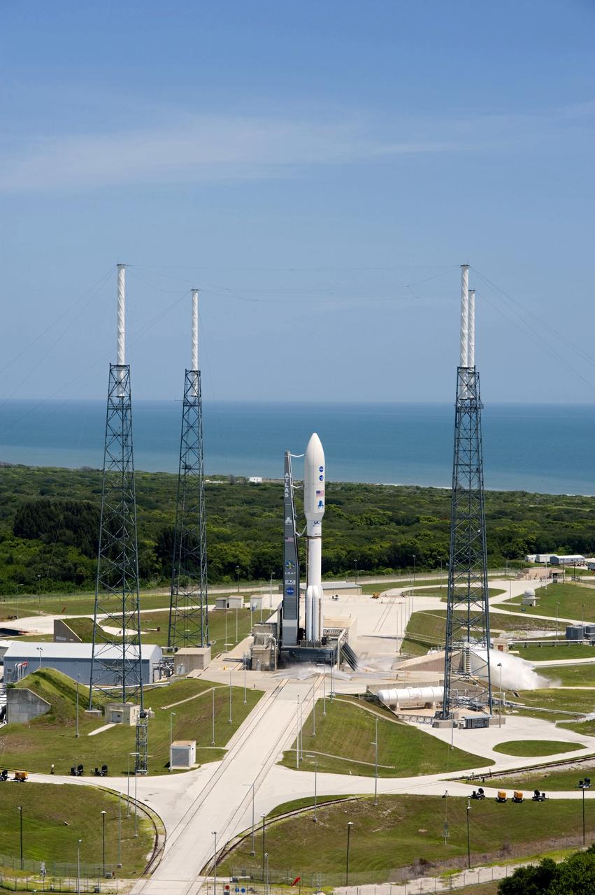 CAPE CANAVERAL, Fla. -- Backdropped by the Atlantic Ocean and surrounded by its four-tower lightning protection system, NASA's Juno planetary probe, enclosed in its payload fairing, is seconds away from liftoff atop a United Launch Alliance Atlas V rocket. Leaving from Space Launch Complex 41 on Cape Canaveral Air Force Station in Florida, the spacecraft will embark on a five-year journey to Jupiter. On the right, water is seen dumping into a flame trench to suppress vibrations at launch.        Liftoff was at 12:25 p.m. EDT Aug. 5. The solar-powered spacecraft will orbit Jupiter's poles 33 times to find out more about the gas giant's origins, structure, atmosphere and magnetosphere and investigate the existence of a solid planetary core. For more information, visit www.nasa.gov/juno. Photo credit: NASA/Tony Gray and Tim Powers