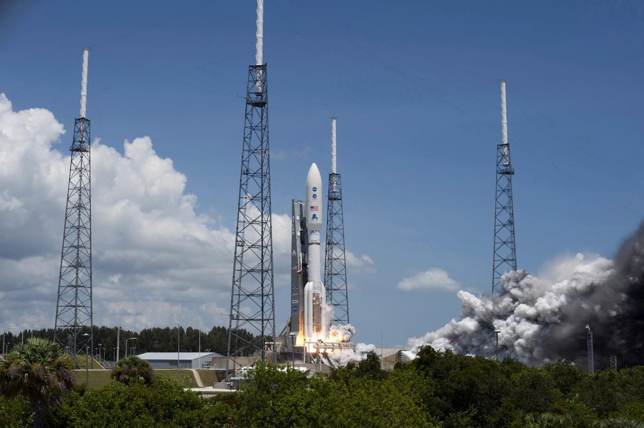 CAPE CANAVERAL, Fla. -- Rising from fire and smoke, NASA's Juno planetary probe, enclosed in its payload fairing, launches atop a United Launch Alliance Atlas V rocket. Leaving from Space Launch Complex 41 and its four lightning protection system towers on Cape Canaveral Air Force Station in Florida, the spacecraft will embark on a five-year journey to Jupiter.        Liftoff was at 12:25 p.m. EDT Aug. 5. The solar-powered spacecraft will orbit Jupiter's poles 33 times to find out more about the gas giant's origins, structure, atmosphere and magnetosphere and investigate the existence of a solid planetary core. For more information, visit www.nasa.gov/juno. Photo credit: NASA/Tony Gray and Don Kight