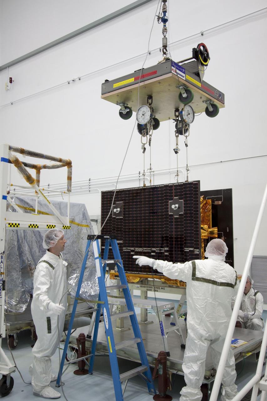 CAPE CANAVERAL, Fla. -- At Astrotech Space Operation's payload processing facility in Titusville, Fla., Lockheed Martin technicians move a portable scale toward one of NASA's twin Gravity Recovery and Interior Laboratory lunar spacecraft. The spacecraft will be lifted and weighed before they are stacked  in their launch configuration in preparation for transport to the launch pad.    GRAIL will fly in tandem orbits around the moon for several months to measure its gravity field. GRAIL's primary science objectives are to determine the structure of the lunar interior, from crust to core, and to advance understanding of the thermal evolution of the moon.  Launch aboard a United Launch Alliance Delta II rocket from Space Launch Complex 17B on Cape Canaveral Air Force Station is scheduled for Sept. 8.  For more information, visit http://www.nasa.gov/grail. Photo credit: NASA/Jim Grossmann