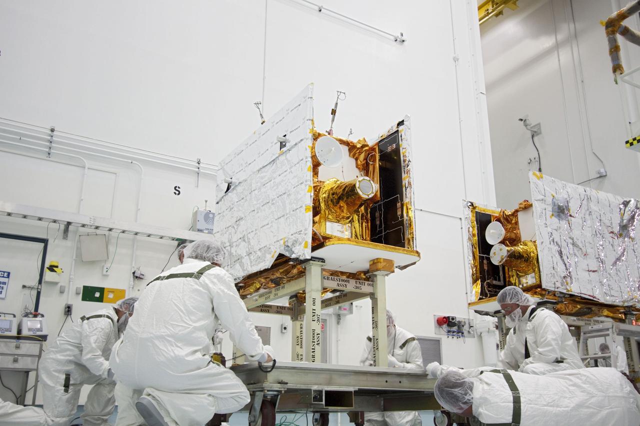 CAPE CANAVERAL, Fla. -- At Astrotech Space Operation's payload processing facility in Titusville, Fla., preparations are under way to stack NASA's twin Gravity Recovery and Interior Laboratory lunar spacecraft in their launch configuration on the spacecraft adapter ring for transport to the launch pad.    GRAIL will fly in tandem orbits around the moon for several months to measure its gravity field. GRAIL's primary science objectives are to determine the structure of the lunar interior, from crust to core, and to advance understanding of the thermal evolution of the moon.  Launch aboard a United Launch Alliance Delta II rocket from Space Launch Complex 17B on Cape Canaveral Air Force Station is scheduled for Sept. 8.  For more information, visit http://www.nasa.gov/grail. Photo credit: NASA/Jim Grossmann