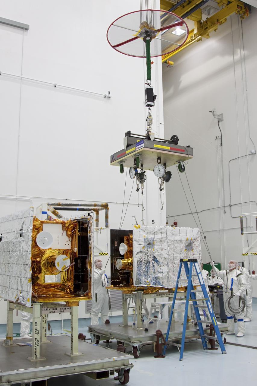 CAPE CANAVERAL, Fla. -- At Astrotech Space Operation's payload processing facility in Titusville, Fla., a lifting device moves into position over NASA's Gravity Recovery and Interior Laboratory-B (GRAIL-B) lunar probe.  At left is GRAIL-A.  After the twin GRAIL spacecraft are attached to the spacecraft adapter ring in their side-by-side launch configuration, they will be transported to the launch pad.    GRAIL will fly in tandem orbits around the moon for several months to measure its gravity field. GRAIL's primary science objectives are to determine the structure of the lunar interior, from crust to core, and to advance understanding of the thermal evolution of the moon.  Launch aboard a United Launch Alliance Delta II rocket from Space Launch Complex 17B on Cape Canaveral Air Force Station is scheduled for Sept. 8.  For more information, visit http://www.nasa.gov/grail. Photo credit: NASA/Jim Grossmann