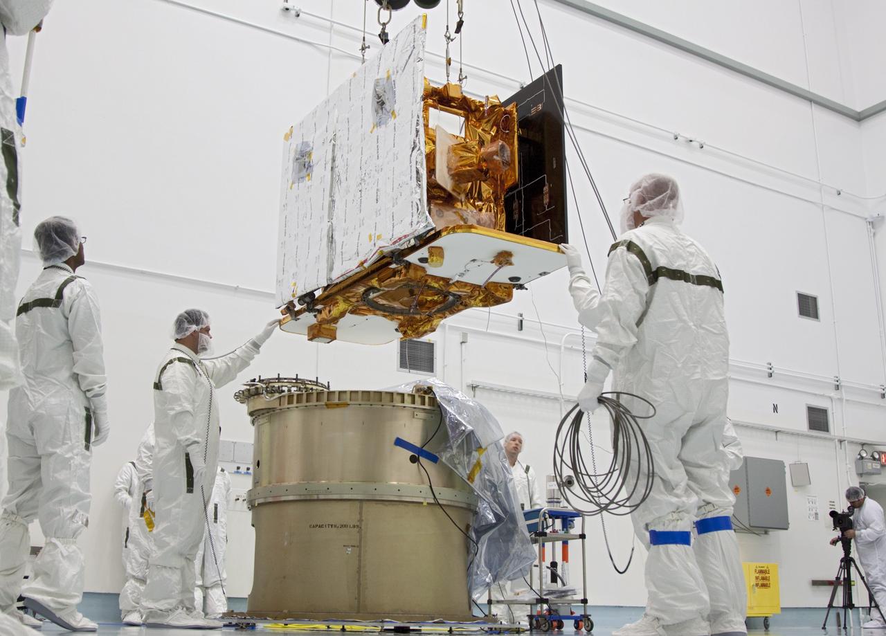 CAPE CANAVERAL, Fla. -- At Astrotech Space Operation's payload processing facility in Titusville, Fla., Lockheed Martin technicians lower NASA's Gravity Recovery and Interior Laboratory-B (GRAIL-B) lunar probe toward the spacecraft adapter ring. After the twin GRAIL spacecraft are attached to the adapter ring in their side-by-side launch configuration, they will be transported to the launch pad.    GRAIL will fly in tandem orbits around the moon for several months to measure its gravity field. GRAIL's primary science objectives are to determine the structure of the lunar interior, from crust to core, and to advance understanding of the thermal evolution of the moon.  Launch aboard a United Launch Alliance Delta II rocket from Space Launch Complex 17B on Cape Canaveral Air Force Station is scheduled for Sept. 8.  For more information, visit http://www.nasa.gov/grail. Photo credit: NASA/Jim Grossmann