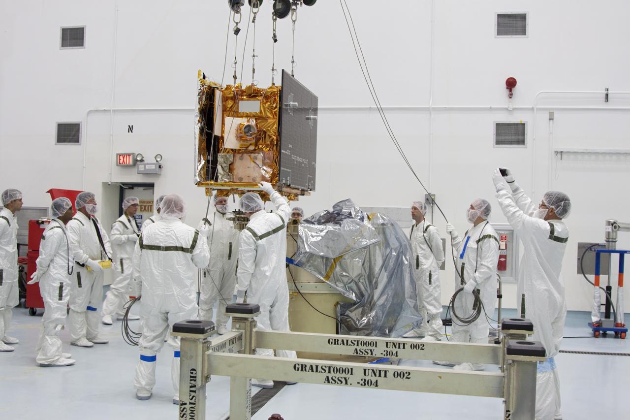 CAPE CANAVERAL, Fla. -- At Astrotech Space Operation's payload processing facility in Titusville, Fla., Lockheed Martin technicians lower NASA's Gravity Recovery and Interior Laboratory-B (GRAIL-B) lunar probe into position on the spacecraft adapter ring. After the twin GRAIL spacecraft are attached to the adapter ring in their side-by-side launch configuration, they will be transported to the launch pad.    GRAIL will fly in tandem orbits around the moon for several months to measure its gravity field. GRAIL's primary science objectives are to determine the structure of the lunar interior, from crust to core, and to advance understanding of the thermal evolution of the moon.  Launch aboard a United Launch Alliance Delta II rocket from Space Launch Complex 17B on Cape Canaveral Air Force Station is scheduled for Sept. 8.  For more information, visit http://www.nasa.gov/grail. Photo credit: NASA/Jim Grossmann