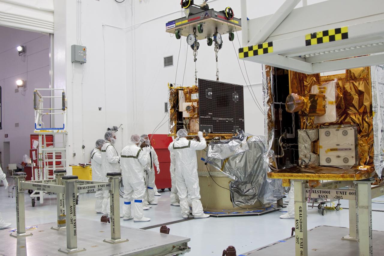 CAPE CANAVERAL, Fla. -- At Astrotech Space Operation's payload processing facility in Titusville, Fla., NASA's Gravity Recovery and Interior Laboratory-B (GRAIL-B) lunar probe comes to rest on the spacecraft adapter ring. At right is GRAIL-A.  After the twin GRAIL spacecraft are attached to the adapter ring in their side-by-side launch configuration, they will be transported to the launch pad.    GRAIL will fly in tandem orbits around the moon for several months to measure its gravity field. GRAIL's primary science objectives are to determine the structure of the lunar interior, from crust to core, and to advance understanding of the thermal evolution of the moon.  Launch aboard a United Launch Alliance Delta II rocket from Space Launch Complex 17B on Cape Canaveral Air Force Station is scheduled for Sept. 8.  For more information, visit http://www.nasa.gov/grail. Photo credit: NASA/Jim Grossmann