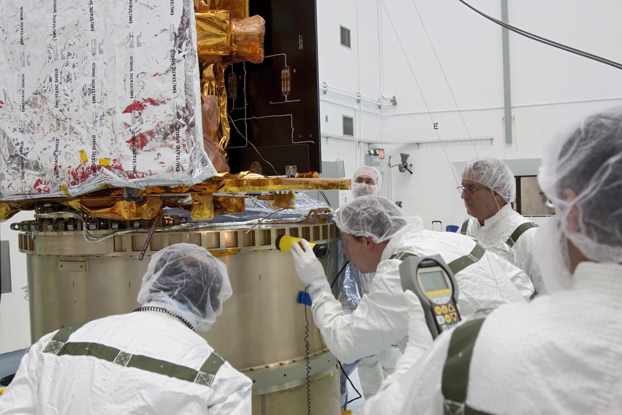 CAPE CANAVERAL, Fla. -- At Astrotech Space Operation's payload processing facility in Titusville, Fla., Lockheed Martin technicians verify that NASA's Gravity Recovery and Interior Laboratory-B (GRAIL-B) lunar probe is in the correct position on the spacecraft adapter ring. After the twin GRAIL spacecraft are attached to the adapter ring in their side-by-side launch configuration, they will be transported to the launch pad.    GRAIL will fly in tandem orbits around the moon for several months to measure its gravity field. GRAIL's primary science objectives are to determine the structure of the lunar interior, from crust to core, and to advance understanding of the thermal evolution of the moon.  Launch aboard a United Launch Alliance Delta II rocket from Space Launch Complex 17B on Cape Canaveral Air Force Station is scheduled for Sept. 8.  For more information, visit http://www.nasa.gov/grail. Photo credit: NASA/Jim Grossmann
