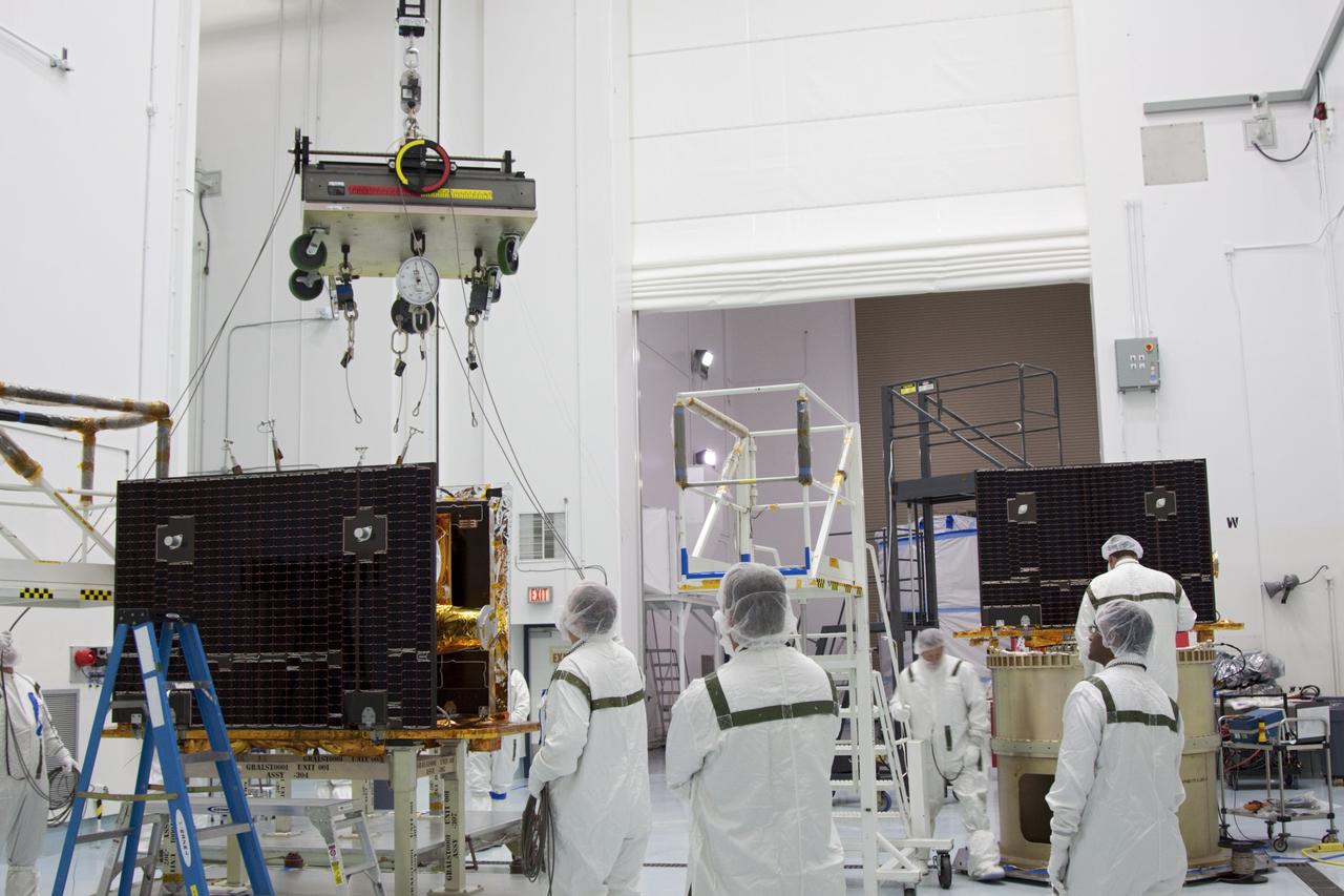 CAPE CANAVERAL, Fla. -- At Astrotech Space Operation's payload processing facility in Titusville, Fla., the lifting device moves toward NASA's Gravity Recovery and Interior Laboratory-A (GRAIL-A) lunar probe.  The spacecraft will be transferred to the spacecraft adapter ring, at right, where GRAIL-B is being secured.  After the twin spacecraft are attached to the adapter ring in their side-by-side launch configuration, they will be transported to the launch pad.    GRAIL will fly in tandem orbits around the moon for several months to measure its gravity field. GRAIL's primary science objectives are to determine the structure of the lunar interior, from crust to core, and to advance understanding of the thermal evolution of the moon.  Launch aboard a United Launch Alliance Delta II rocket from Space Launch Complex 17B on Cape Canaveral Air Force Station is scheduled for Sept. 8.  For more information, visit http://www.nasa.gov/grail. Photo credit: NASA/Jim Grossmann