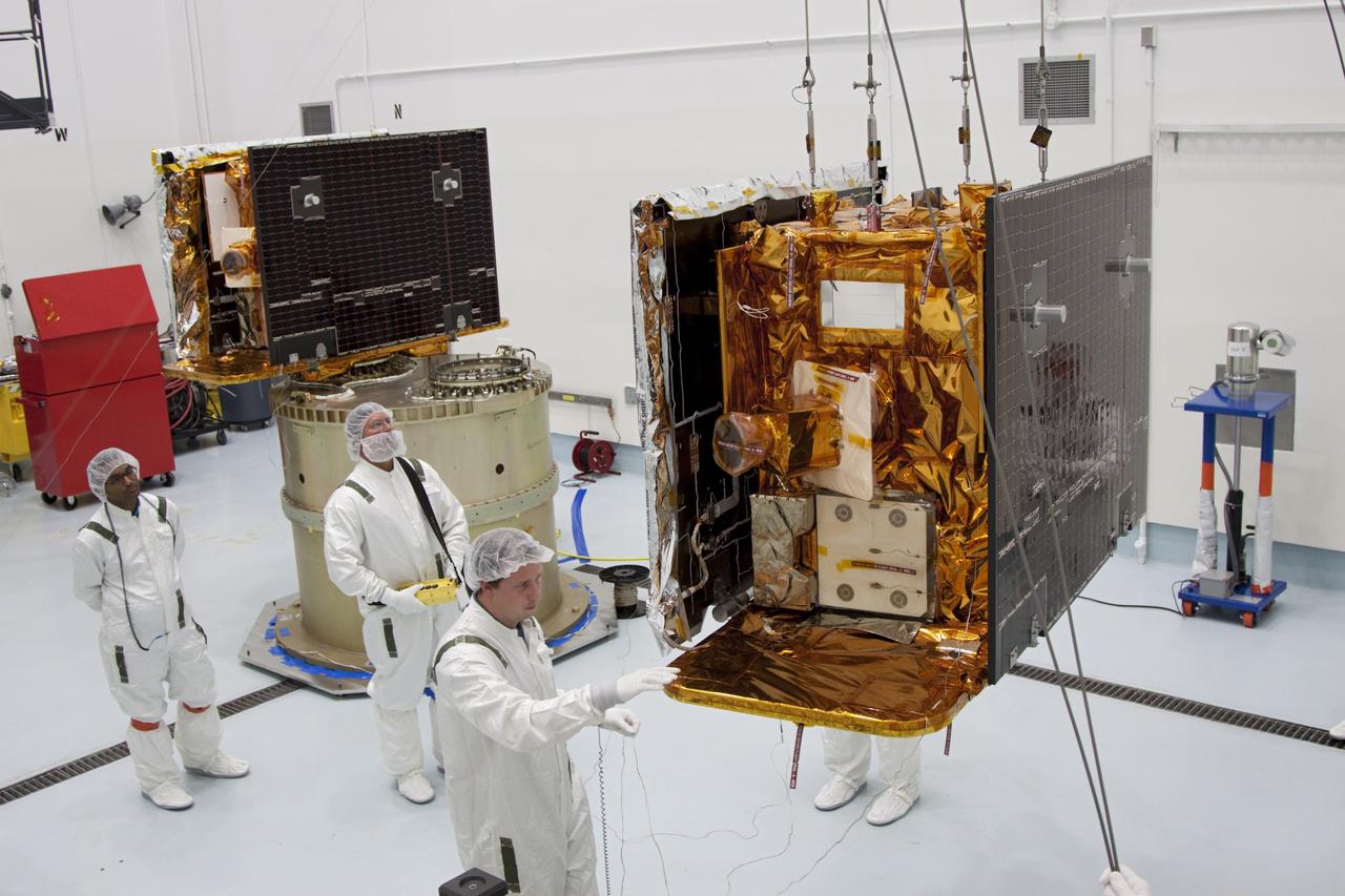 CAPE CANAVERAL, Fla. -- At Astrotech Space Operation's payload processing facility in Titusville, Fla., NASA's Gravity Recovery and Interior Laboratory-A (GRAIL-A) lunar probe is lifted from its workstand and across the clean room toward the spacecraft adapter ring, at left, where GRAIL-B is already secured.  After the twin GRAIL spacecraft are attached to the adapter ring in their side-by-side launch configuration, they will be transported to the launch pad.    GRAIL will fly in tandem orbits around the moon for several months to measure its gravity field. GRAIL's primary science objectives are to determine the structure of the lunar interior, from crust to core, and to advance understanding of the thermal evolution of the moon.  Launch aboard a United Launch Alliance Delta II rocket from Space Launch Complex 17B on Cape Canaveral Air Force Station is scheduled for Sept. 8.  For more information, visit http://www.nasa.gov/grail. Photo credit: NASA/Jim Grossmann