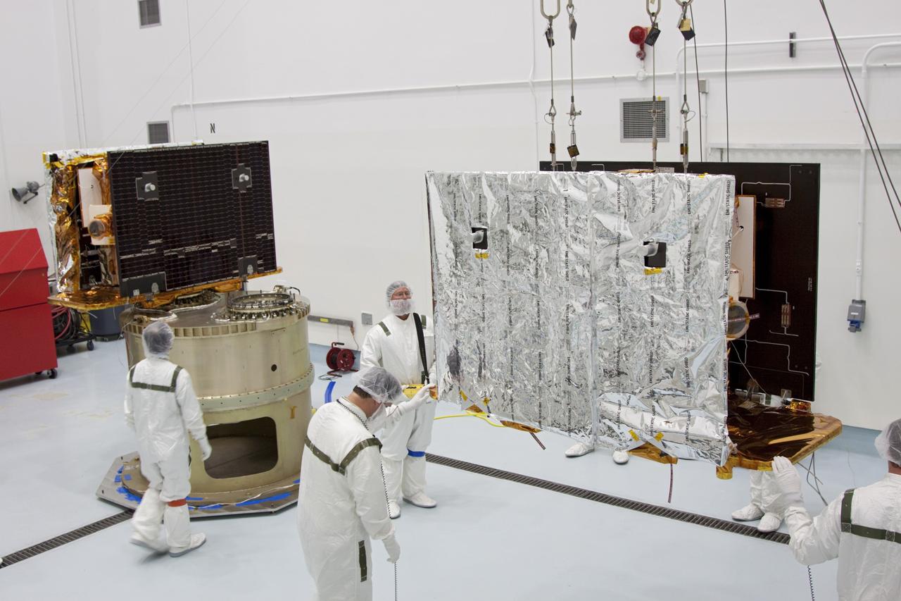 CAPE CANAVERAL, Fla. -- At Astrotech Space Operation's payload processing facility in Titusville, Fla., NASA's Gravity Recovery and Interior Laboratory-A (GRAIL-A) lunar probe moves across the clean room toward the spacecraft adapter ring, at left, where GRAIL-B is already secured.  After the twin GRAIL spacecraft are attached to the adapter ring in their side-by-side launch configuration, they will be transported to the launch pad.    GRAIL will fly in tandem orbits around the moon for several months to measure its gravity field. GRAIL's primary science objectives are to determine the structure of the lunar interior, from crust to core, and to advance understanding of the thermal evolution of the moon.  Launch aboard a United Launch Alliance Delta II rocket from Space Launch Complex 17B on Cape Canaveral Air Force Station is scheduled for Sept. 8.  For more information, visit http://www.nasa.gov/grail. Photo credit: NASA/Jim Grossmann