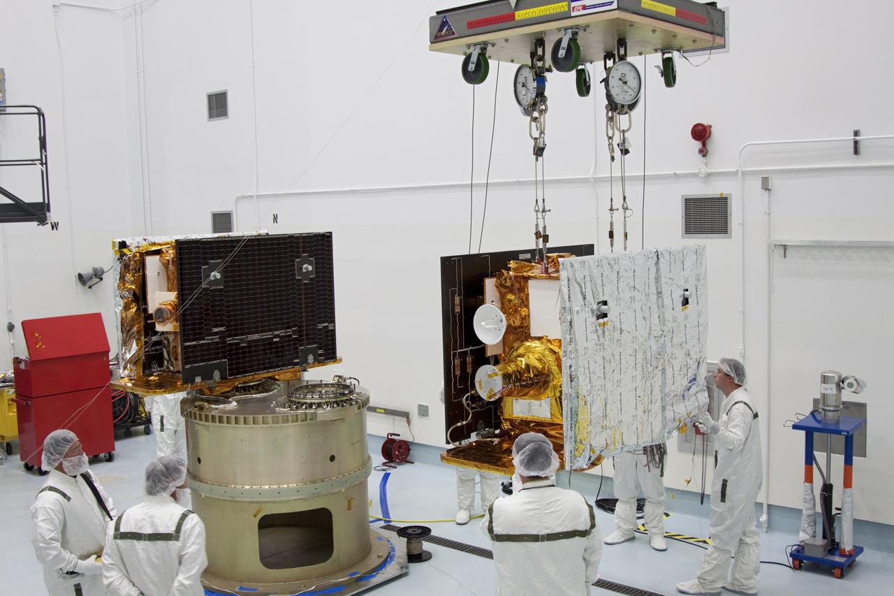CAPE CANAVERAL, Fla. -- At Astrotech Space Operation's payload processing facility in Titusville, Fla., NASA's Gravity Recovery and Interior Laboratory-A (GRAIL-A) lunar probe slowly approaches the spacecraft adapter ring, at left, where GRAIL-B is already secured.  After the twin GRAIL spacecraft are attached to the adapter ring in their side-by-side launch configuration, they will be transported to the launch pad.    GRAIL will fly in tandem orbits around the moon for several months to measure its gravity field. GRAIL's primary science objectives are to determine the structure of the lunar interior, from crust to core, and to advance understanding of the thermal evolution of the moon.  Launch aboard a United Launch Alliance Delta II rocket from Space Launch Complex 17B on Cape Canaveral Air Force Station is scheduled for Sept. 8.  For more information, visit http://www.nasa.gov/grail. Photo credit: NASA/Jim Grossmann
