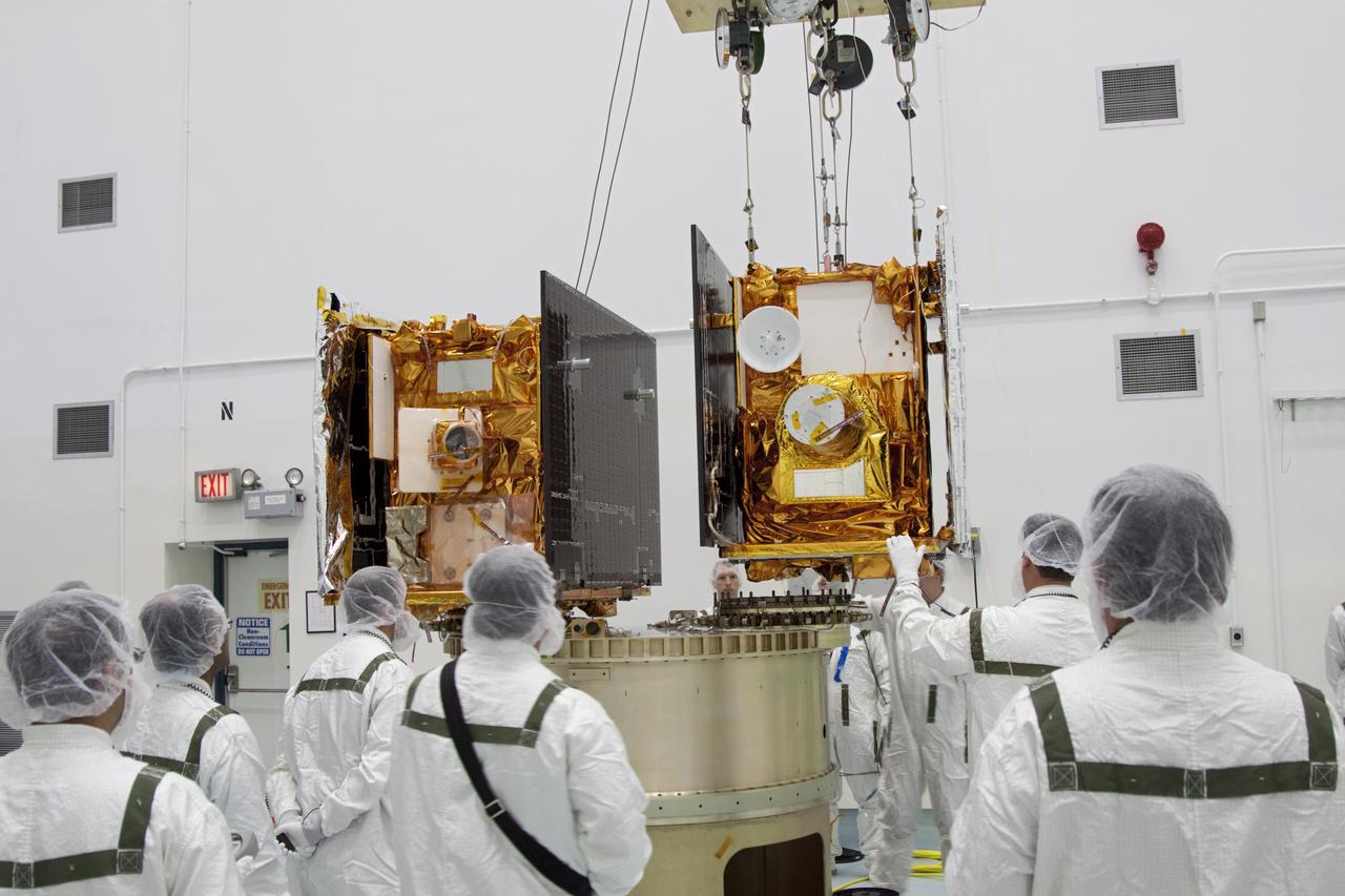 CAPE CANAVERAL, Fla. -- At Astrotech Space Operation's payload processing facility in Titusville, Fla., NASA's Gravity Recovery and Interior Laboratory-A (GRAIL-A) lunar probe us lowered toward the spacecraft adapter ring.  GRAIL-B is already secured to the ring, at left.  After the twin GRAIL spacecraft are attached to the adapter ring in their side-by-side launch configuration, they will be transported to the launch pad.    GRAIL will fly in tandem orbits around the moon for several months to measure its gravity field. GRAIL's primary science objectives are to determine the structure of the lunar interior, from crust to core, and to advance understanding of the thermal evolution of the moon.  Launch aboard a United Launch Alliance Delta II rocket from Space Launch Complex 17B on Cape Canaveral Air Force Station is scheduled for Sept. 8.  For more information, visit http://www.nasa.gov/grail. Photo credit: NASA/Jim Grossmann
