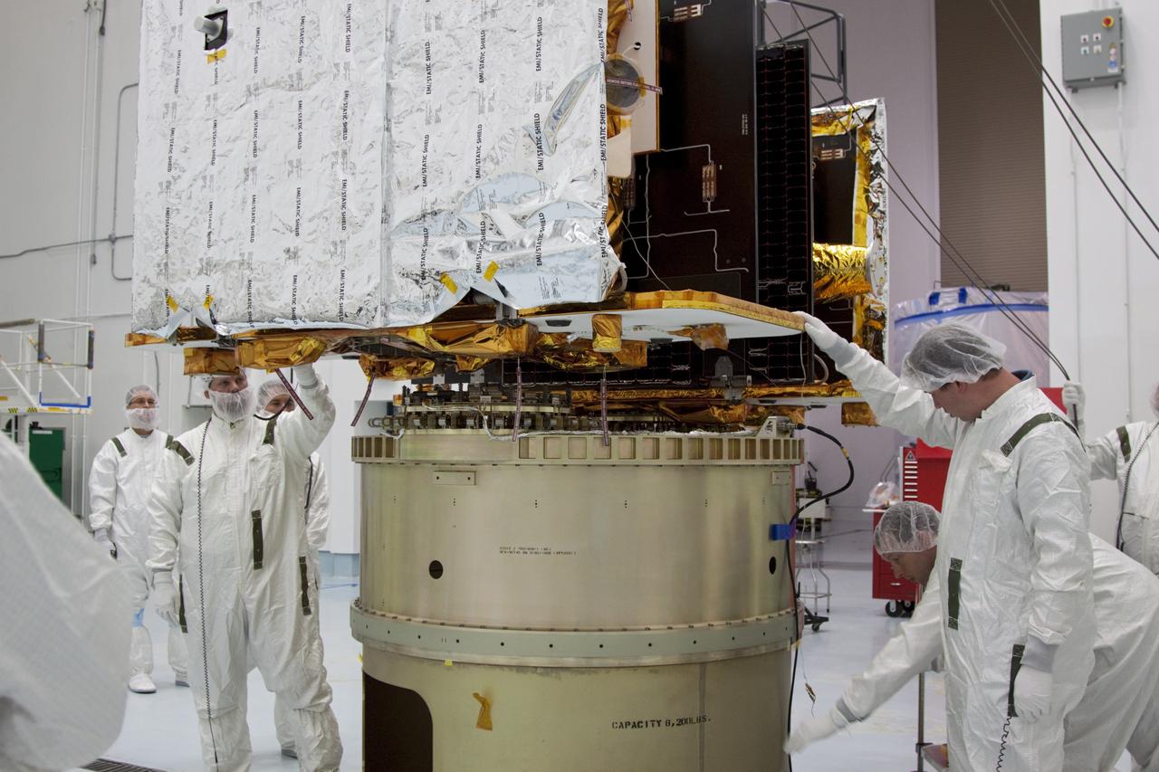 CAPE CANAVERAL, Fla. -- At Astrotech Space Operation's payload processing facility in Titusville, Fla., Lockheed Martin technicians verify that NASA's Gravity Recovery and Interior Laboratory-A (GRAIL-A) lunar probe is lowered into the correct position on the spacecraft adapter ring. After the twin GRAIL spacecraft are attached to the adapter ring in their side-by-side launch configuration, they will be transported to the launch pad.    GRAIL will fly in tandem orbits around the moon for several months to measure its gravity field. GRAIL's primary science objectives are to determine the structure of the lunar interior, from crust to core, and to advance understanding of the thermal evolution of the moon.  Launch aboard a United Launch Alliance Delta II rocket from Space Launch Complex 17B on Cape Canaveral Air Force Station is scheduled for Sept. 8.  For more information, visit http://www.nasa.gov/grail. Photo credit: NASA/Jim Grossmann