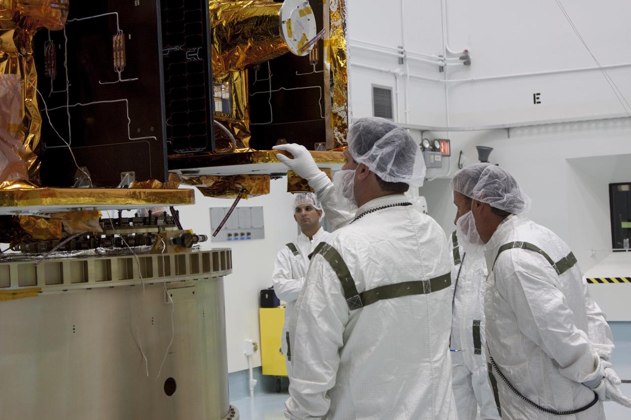 CAPE CANAVERAL, Fla. -- At Astrotech Space Operation's payload processing facility in Titusville, Fla., Lockheed Martin technicians verify that NASA's Gravity Recovery and Interior Laboratory-A (GRAIL-A) lunar probe is positioned correctly on the spacecraft adapter ring. After the twin GRAIL spacecraft are attached to the adapter ring in their side-by-side launch configuration, they will be transported to the launch pad.    GRAIL will fly in tandem orbits around the moon for several months to measure its gravity field. GRAIL's primary science objectives are to determine the structure of the lunar interior, from crust to core, and to advance understanding of the thermal evolution of the moon.  Launch aboard a United Launch Alliance Delta II rocket from Space Launch Complex 17B on Cape Canaveral Air Force Station is scheduled for Sept. 8.  For more information, visit http://www.nasa.gov/grail. Photo credit: NASA/Jim Grossmann
