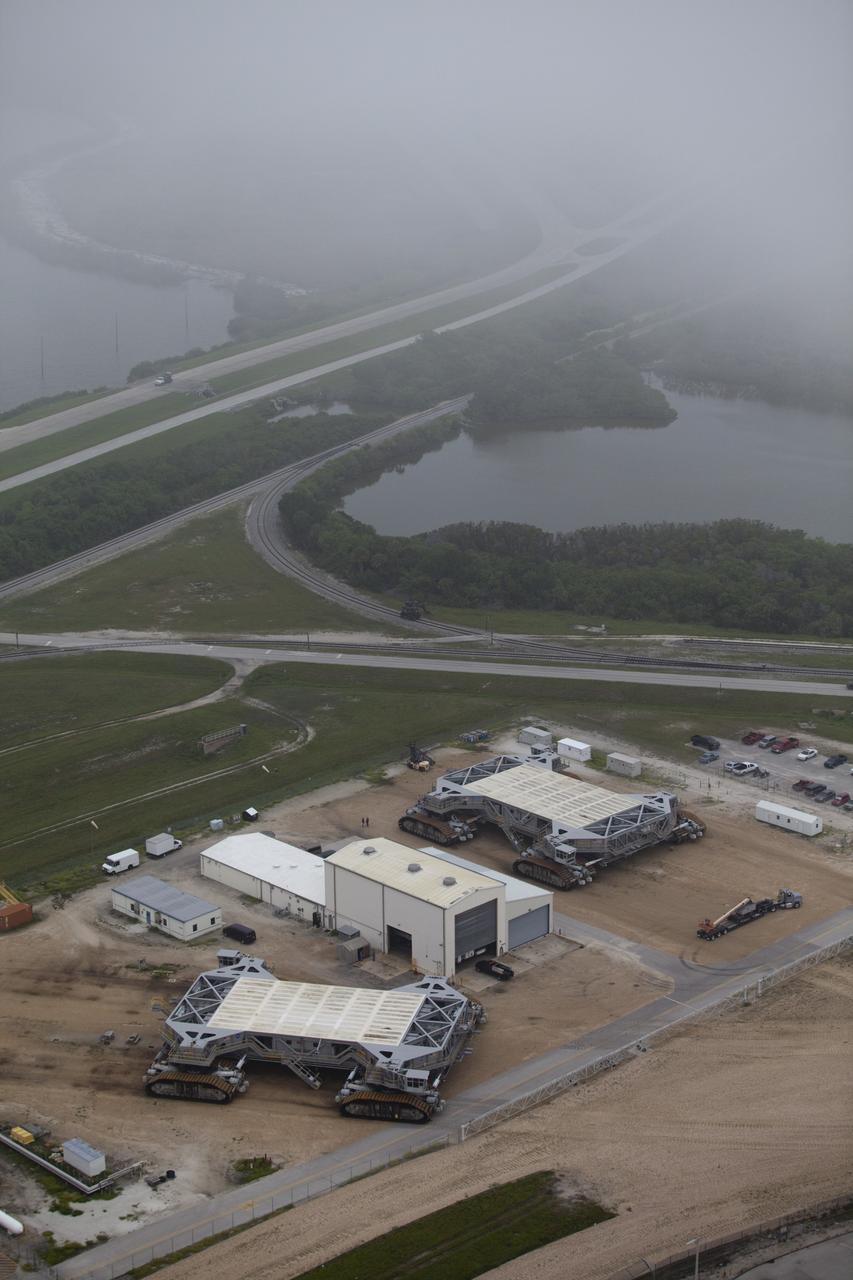 CAPE CANAVERAL, Fla. -- At NASA's Kennedy Space Center in Florida, the 5.5-million-pound crawler transporters await the opportunity to support NASA's future spaceflight programs. The crawlers originally were built to support the Saturn rockets in NASA's Apollo lunar landing program. The image was taken from the top of the Vehicle Assembly Building (VAB). For more information, visit http://www.nasa.gov/centers/kennedy/pdf/167402main_crawlertransporters07.pdf. Photo credit: Frankie Martin