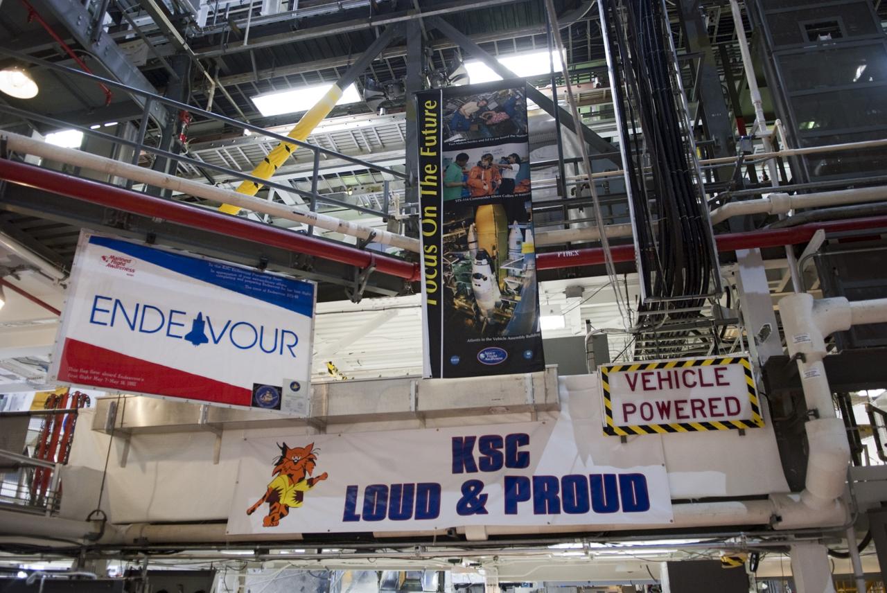 CAPE CANAVERAL, Fla. -- At NASA's Kennedy Space Center in Florida, a banner in Orbiter Processing Facility-1 (OPF-1) proclaims the pride of the center's employees as preparations are made to move space shuttle Endeavour to the Vehicle Assembly Building (VAB).  Endeavour is switching places with shuttle Discovery which temporarily has been stored in the VAB.  Both shuttles will stop briefly outside OPF-3 for a "nose-to-nose" photo opportunity. Discovery then will be rolled into OPF-1 and Endeavour into the VAB.    In OPF-1, Discovery will undergo further preparations for public display at the Smithsonian's National Air and Space Museum Steven F. Udvar-Hazy Center in Virginia. Endeavour will be stored in the VAB until October when it will be moved into OPF-2 for further work to get it ready for public display at the California Science Center in Los Angeles.  For more information, visit http://www.nasa.gov/shuttle. Photo credit: NASA/Jim Grossmann