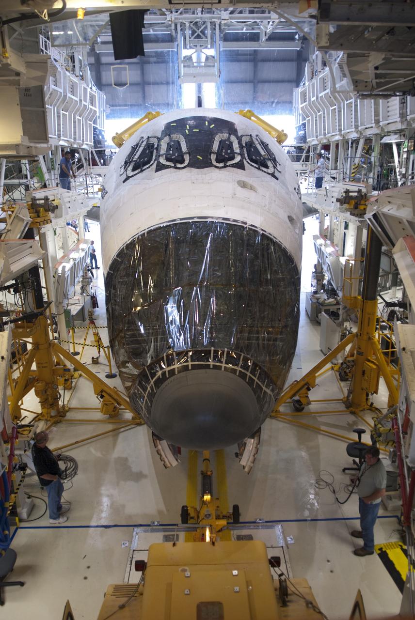 CAPE CANAVERAL, Fla. -- At NASA's Kennedy Space Center in Florida, operators begin to move space shuttle Endeavour, its nose encased in protective plastic where its forward reaction control system (FRCS) once resided, from Orbiter Processing Facility-1 (OPF-1) to the Vehicle Assembly Building (VAB). Endeavour is switching places with shuttle Discovery which temporarily has been stored in the VAB. Both shuttles will stop briefly outside OPF-3 for a "nose-to-nose" photo opportunity. Discovery then will be rolled into OPF-1 and Endeavour into the VAB. In OPF-1, Discovery will undergo further preparations for public display at the Smithsonian's National Air and Space Museum Steven F. Udvar-Hazy Center in Virginia. Endeavour will be stored in the VAB until October when it will be moved into OPF-2 for further work to get it ready for public display at the California Science Center in Los Angeles. For more information, visit http://www.nasa.gov/shuttle. Photo credit: NASA/Jim Grossmann