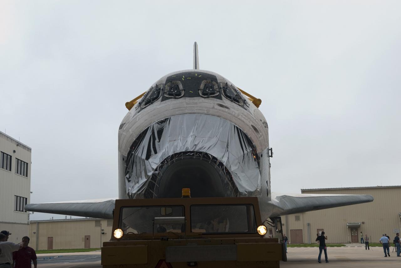 CAPE CANAVERAL, Fla. -- At NASA's Kennedy Space Center in Florida, space shuttle Endeavour, its nose encased in protective plastic where its forward reaction control system (FRCS) once resided, is towed out of Orbiter Processing Facility-1 (OPF-1) for its move to the Vehicle Assembly Building (VAB). Endeavour is switching places with shuttle Discovery which temporarily has been stored in the VAB. Both shuttles will stop briefly outside OPF-3 for a "nose-to-nose" photo opportunity. Discovery then will be rolled into OPF-1 and Endeavour into the VAB. In OPF-1, Discovery will undergo further preparations for public display at the Smithsonian's National Air and Space Museum Steven F. Udvar-Hazy Center in Virginia. Endeavour will be stored in the VAB until October when it will be moved into OPF-2 for further work to get it ready for public display at the California Science Center in Los Angeles. For more information, visit http://www.nasa.gov/shuttle. Photo credit: NASA/Jim Grossmann