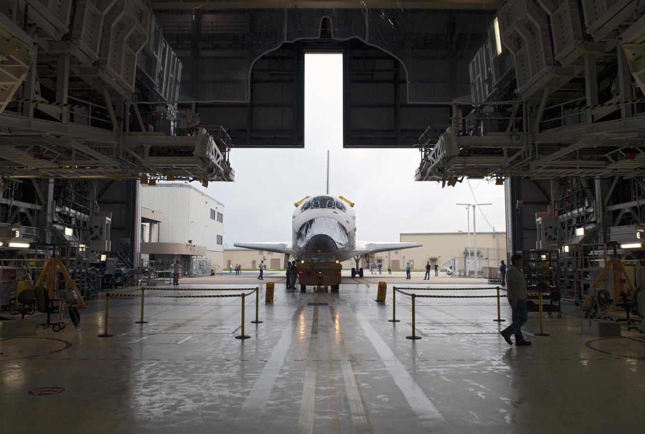 CAPE CANAVERAL, Fla. -- At NASA's Kennedy Space Center in Florida, space shuttle Endeavour vacates the work platforms of Orbiter Processing Facility-1 (OPF-1) to make way for shuttle Discovery.  Endeavour is switching places with Discovery which temporarily has been stored in the Vehicle Assembly Building (VAB).  Both shuttles will stop briefly outside OPF-3 for a "nose-to-nose" photo opportunity. Discovery then will be rolled into OPF-1 and Endeavour into the VAB.      In OPF-1, Discovery will undergo further preparations for public display at the Smithsonian's National Air and Space Museum Steven F. Udvar-Hazy Center in Virginia. Endeavour will be stored in the VAB until October when it will be moved into OPF-2 for further work to get it ready for public display at the California Science Center in Los Angeles.  For more information, visit http://www.nasa.gov/shuttle. Photo credit: NASA/Jim Grossmann