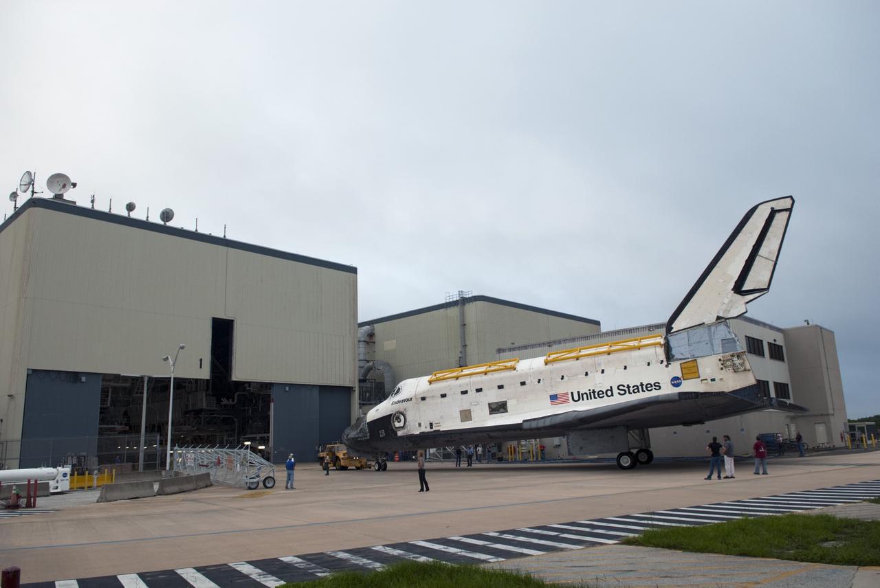 CAPE CANAVERAL, Fla. -- At NASA's Kennedy Space Center in Florida, space shuttle Endeavour sits outside Orbiter Processing Facility-1 (OPF-1), ready for its short jaunt to the Vehicle Assembly Building (VAB).  Endeavour is switching places with shuttle Discovery which temporarily has been stored in the VAB.  Both shuttles will stop briefly outside OPF-3 for a "nose-to-nose" photo opportunity. Discovery then will be rolled into OPF-1 and Endeavour into the VAB.    In OPF-1, Discovery will undergo further preparations for public display at the Smithsonian's National Air and Space Museum Steven F. Udvar-Hazy Center in Virginia. Endeavour will be stored in the VAB until October when it will be moved into OPF-2 for further work to get it ready for public display at the California Science Center in Los Angeles.  For more information, visit http://www.nasa.gov/shuttle. Photo credit: NASA/Jim Grossmann